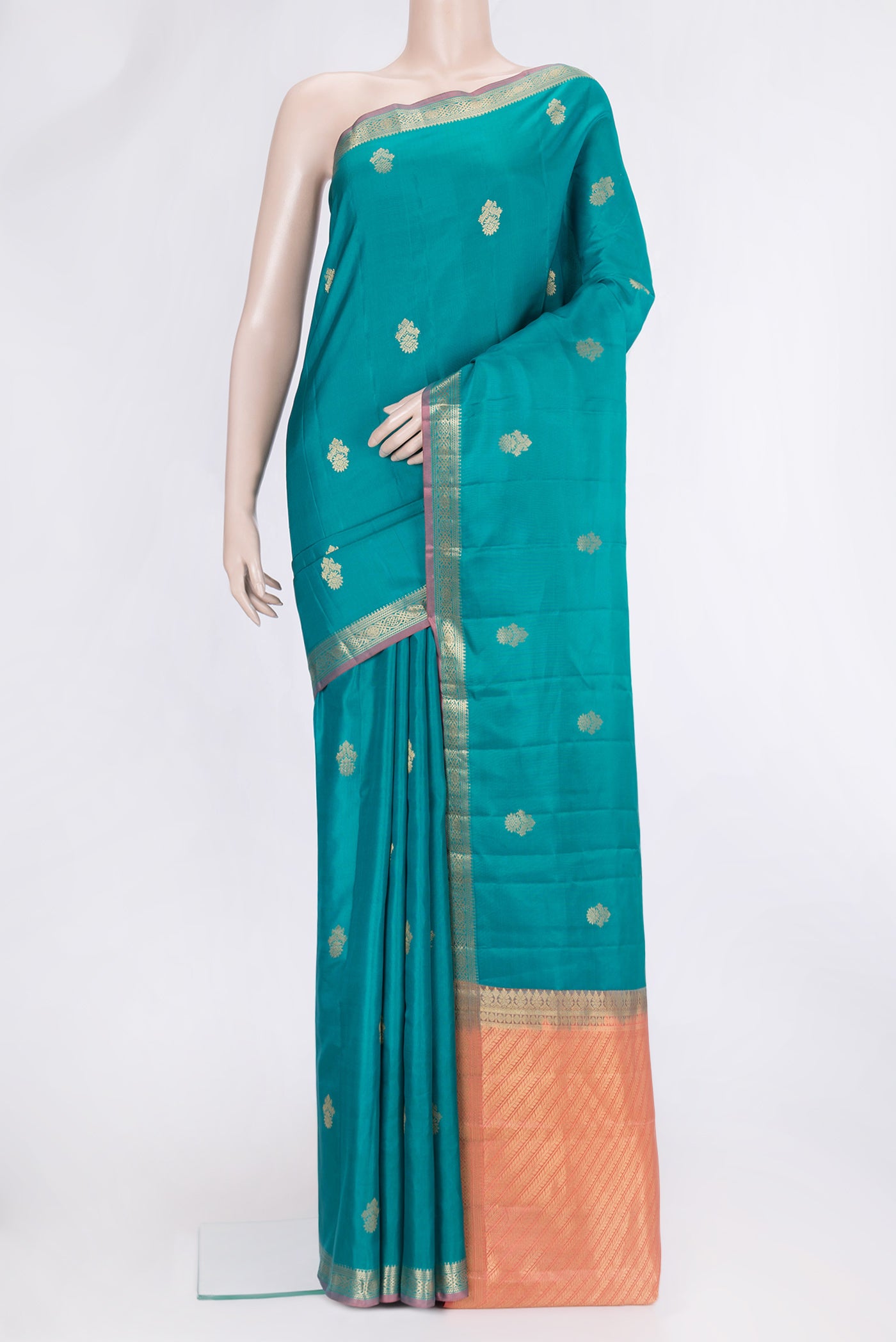 Green Dual Tone Kanjivaram Silk Saree with Zari Butta on the body and Zari Border.  displayed on a mannequin