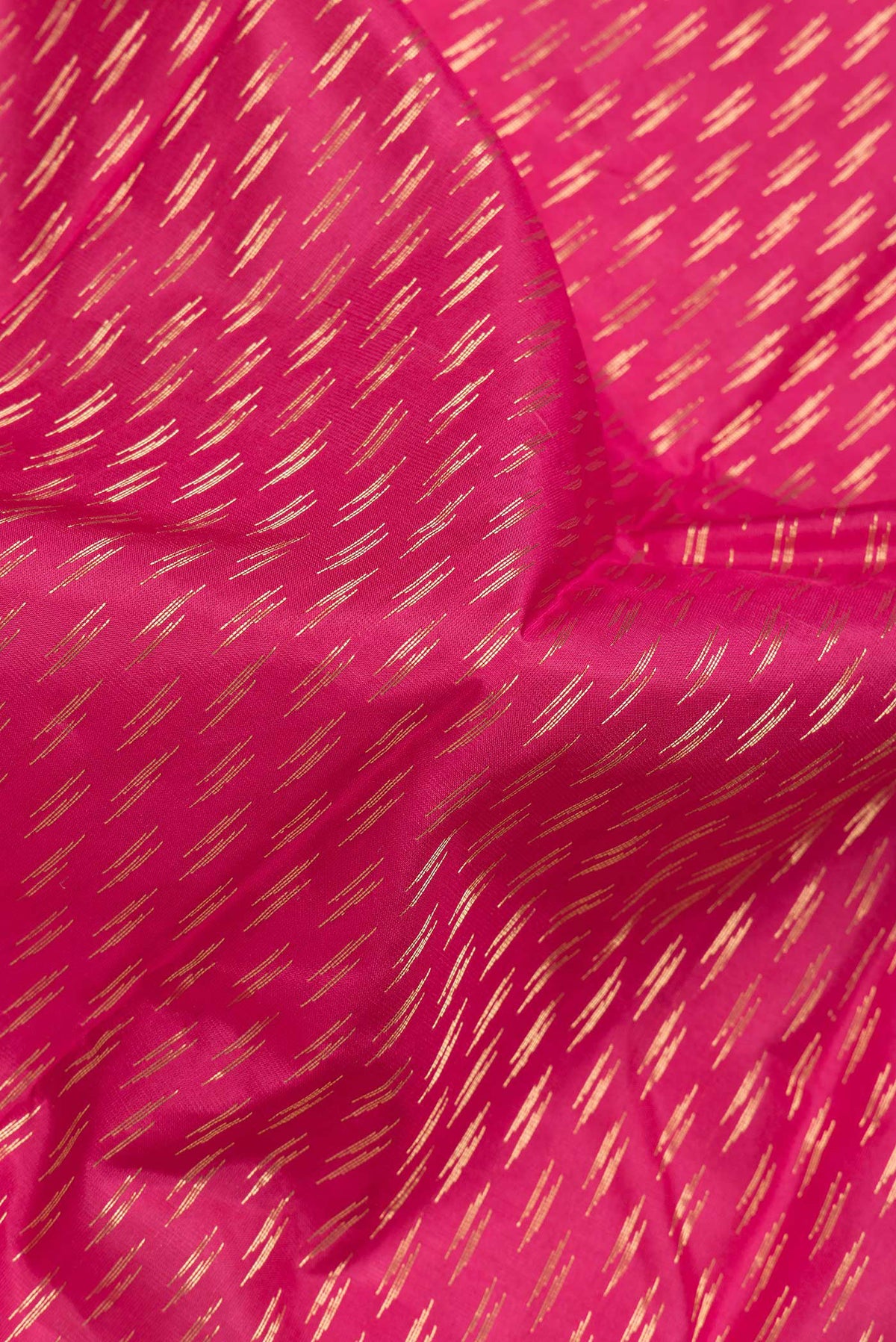 Close up of Pink Dual Tone Kanchipuram Silk Saree with Zari Butta on the body and Zari Border.  displaying folds