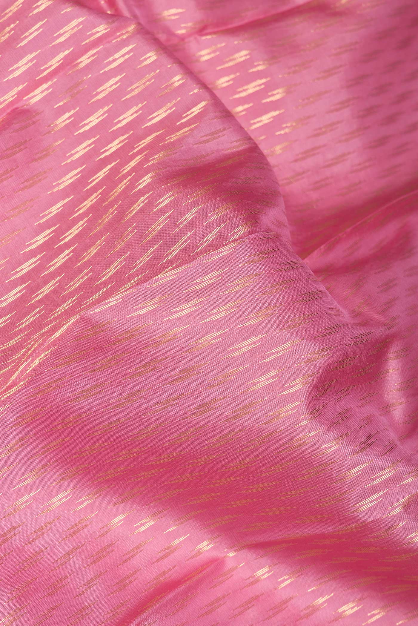 Close up of Pink Dual Tone Kanchipuram Silk Saree with Zari Butta on the body and Zari Border.  displaying folds