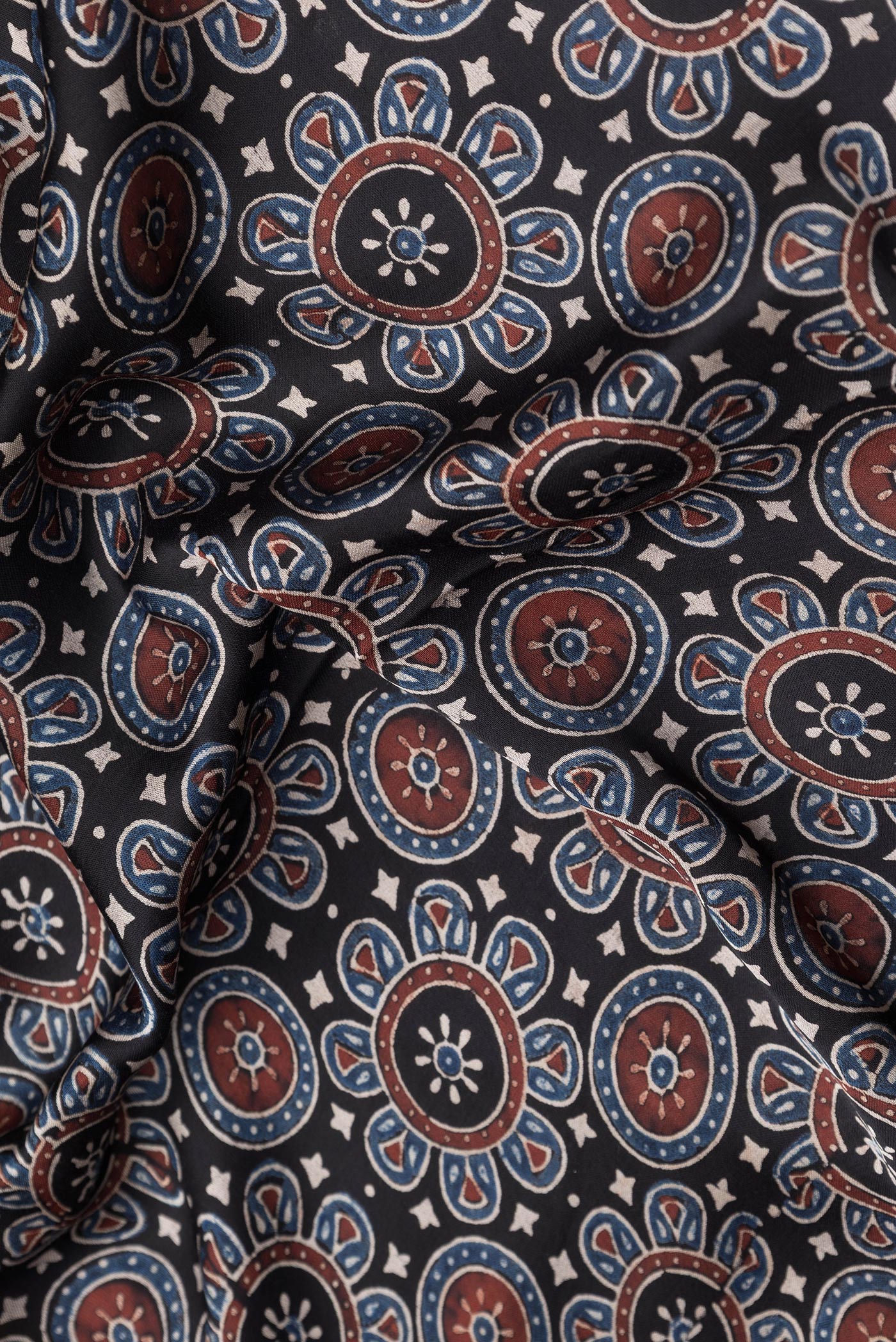 Close up of Black Dual Tone Crepe Saree with Ajrakh Print on the body and Printed Border.  displaying folds