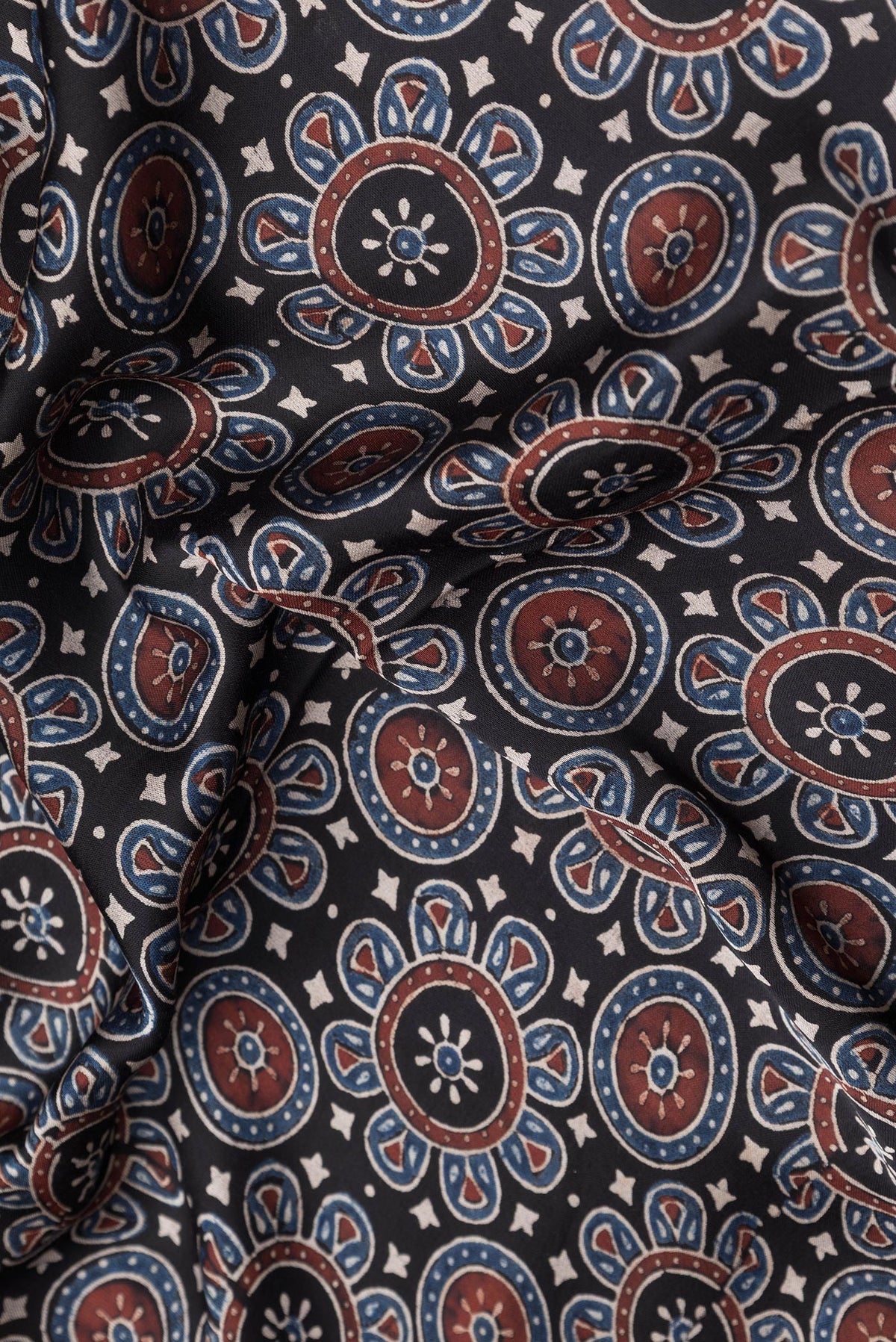 Close up of Black Dual Tone Crepe Saree with Ajrakh Print on the body and Printed Border.  displaying folds