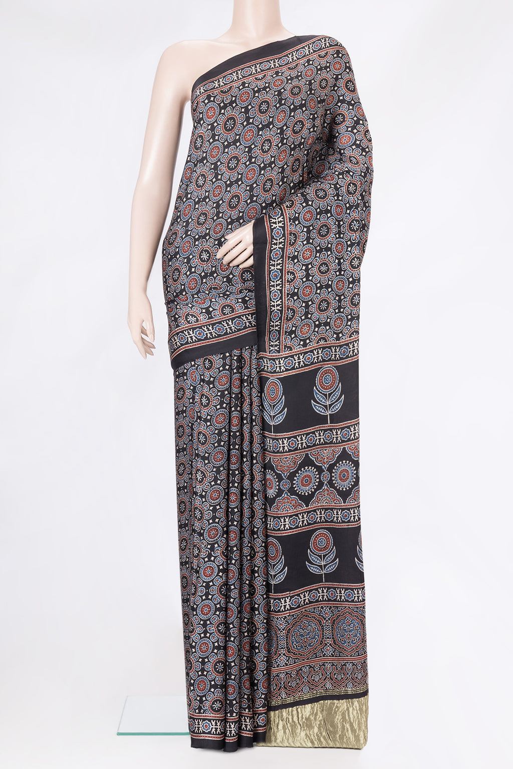 Black Dual Tone Crepe Saree with Ajrakh Print on the body and Printed Border.  displayed on a mannequin