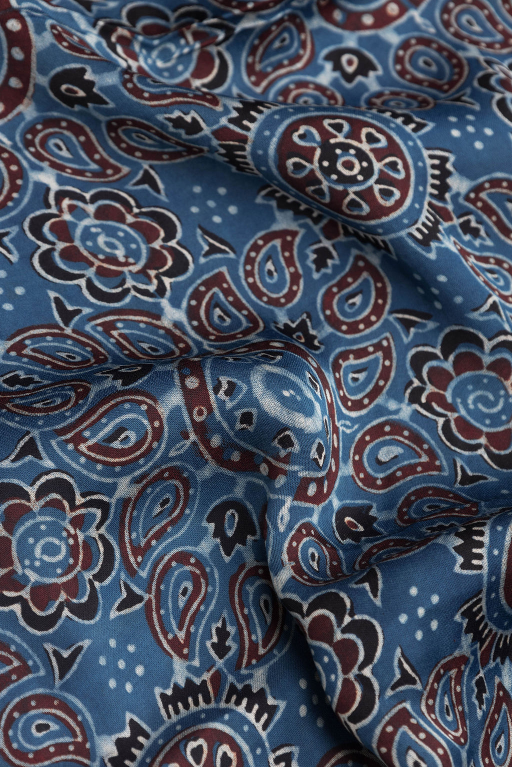 Close up of Grey Dual Tone Crepe Saree with Ajrakh Print on the body and Printed Border.  displaying folds