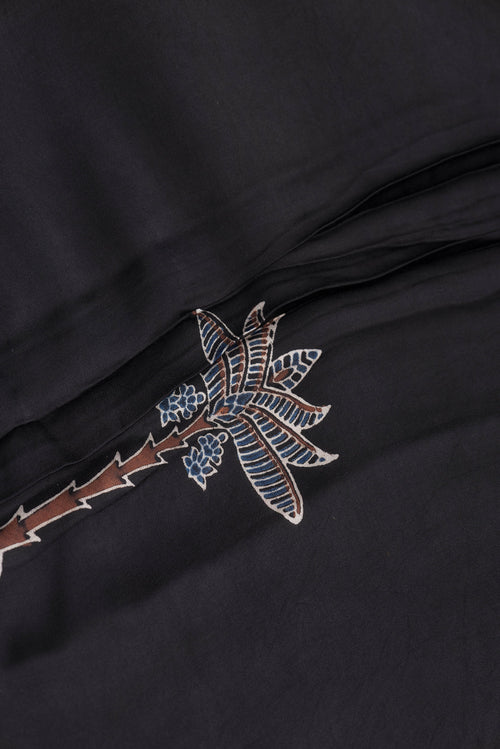 Close up of Black Dual Tone Blended Crepe Saree with Ajrakh Print on the body and Printed Border.  displaying folds
