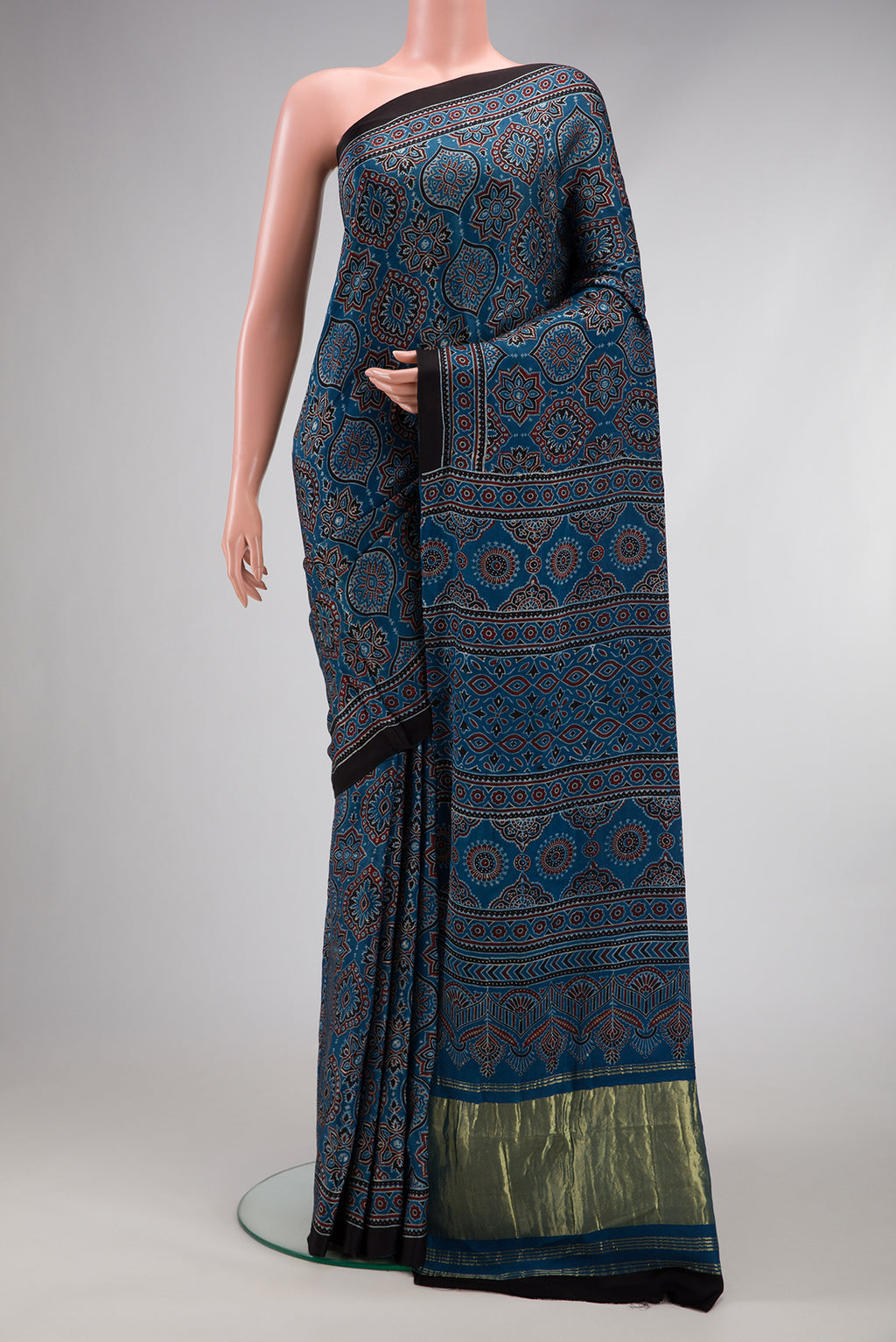 Navy Blue Dual Tone Crepe Saree with Ajrakh Print on the body and Printed Border.  displayed on a mannequin