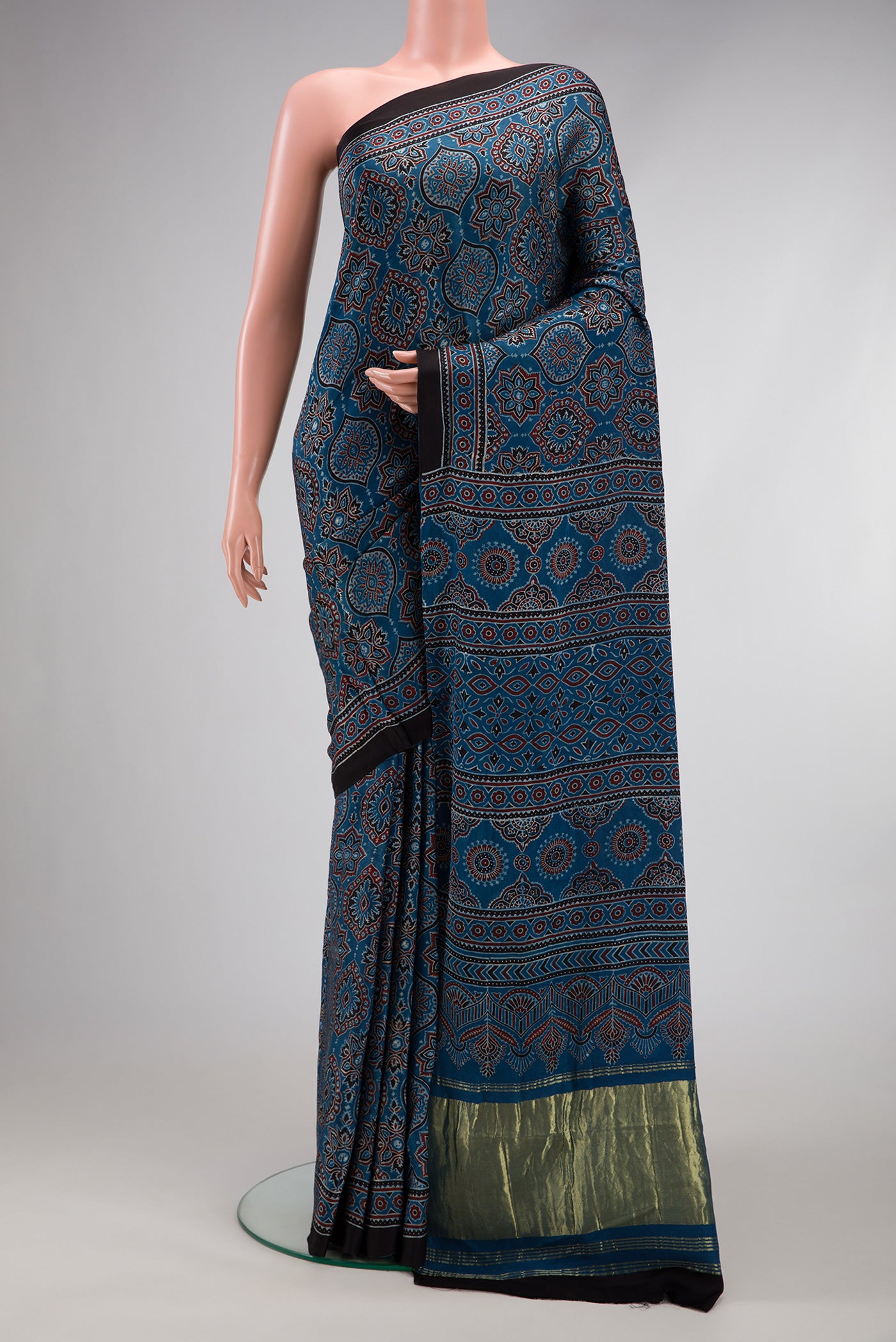 Navy Blue Dual Tone Crepe Saree with Ajrakh Print on the body and Printed Border.  displayed on a mannequin