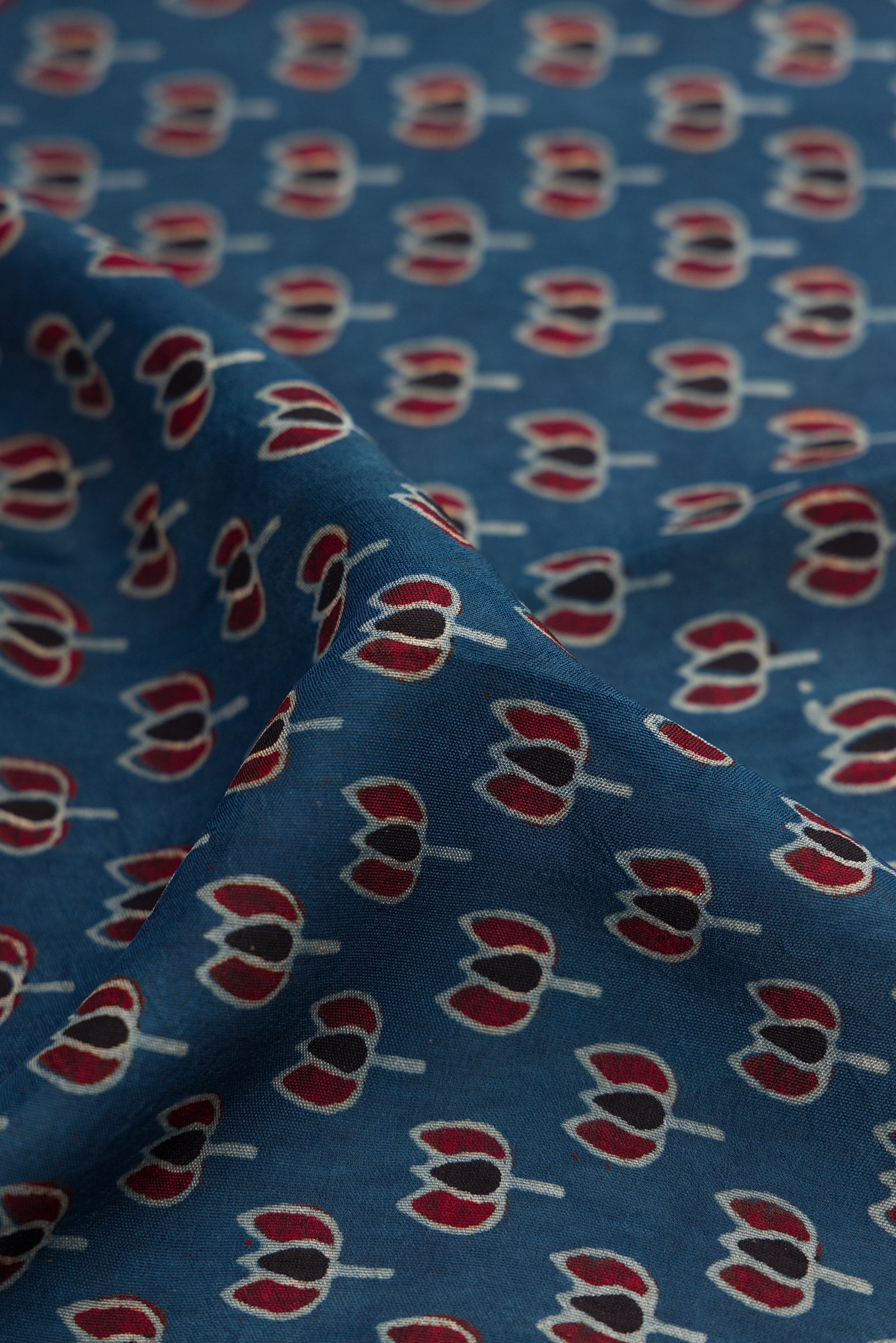 Close up of Navy Blue Dual Tone Tussar Silk Saree with Ajrakh Print on the body and Fancy Border.  displaying folds