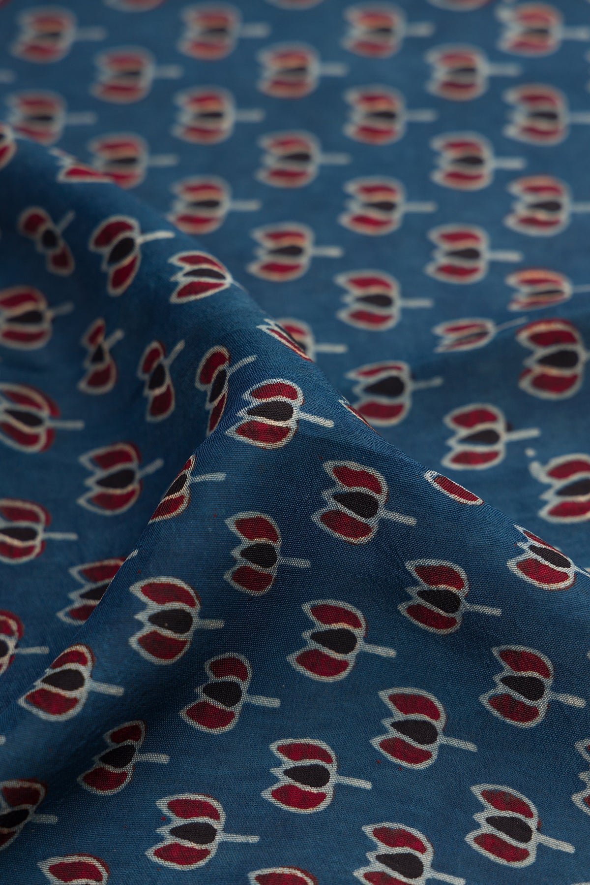 Close up of Navy Blue Dual Tone Tussar Silk Saree with Ajrakh Print on the body and Fancy Border.  displaying folds