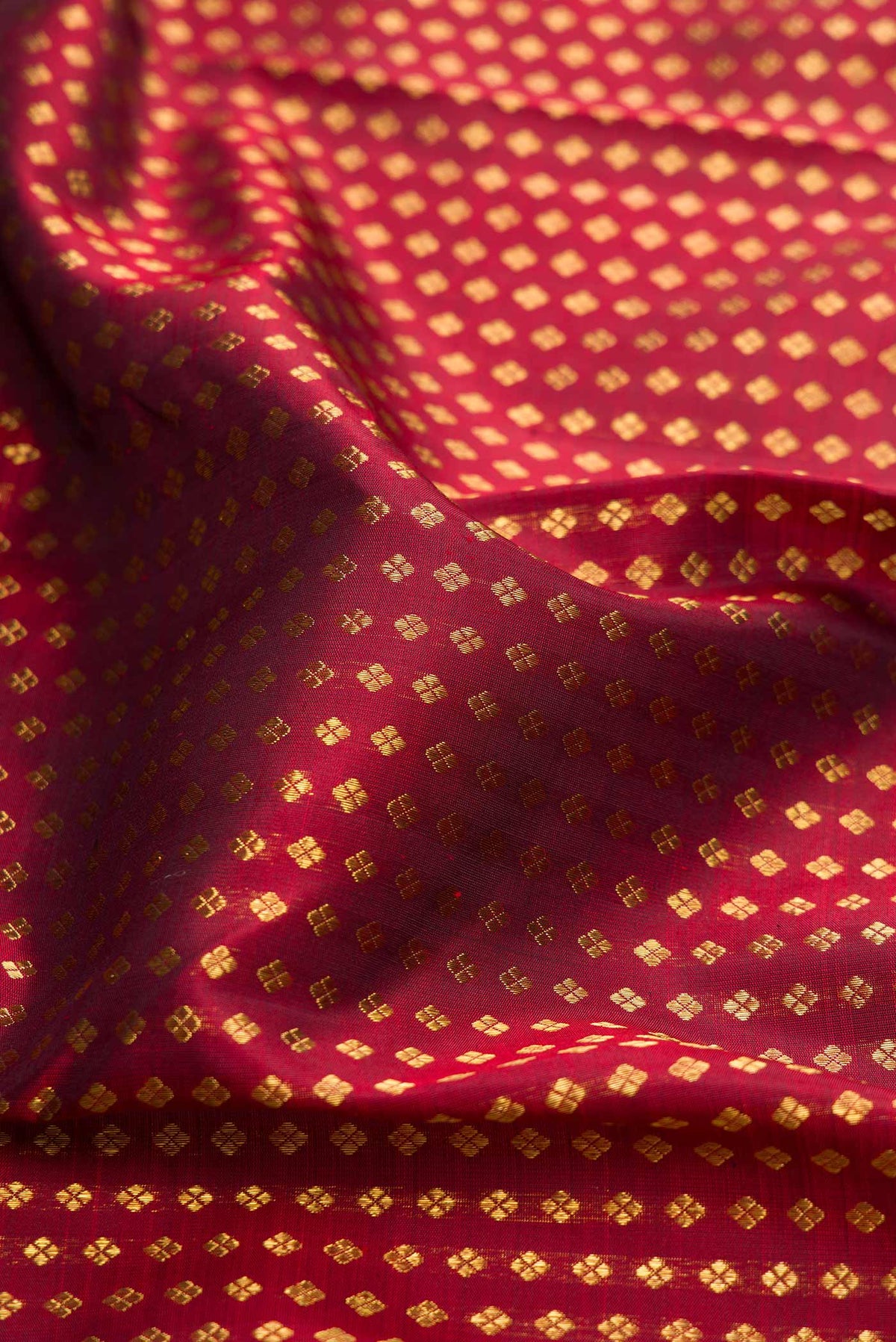 Close up of Pure Silk Pure Zari Maroon Dual Tone Kanchipuram Saree with Zari Brocade on the body and Zari Border displaying folds