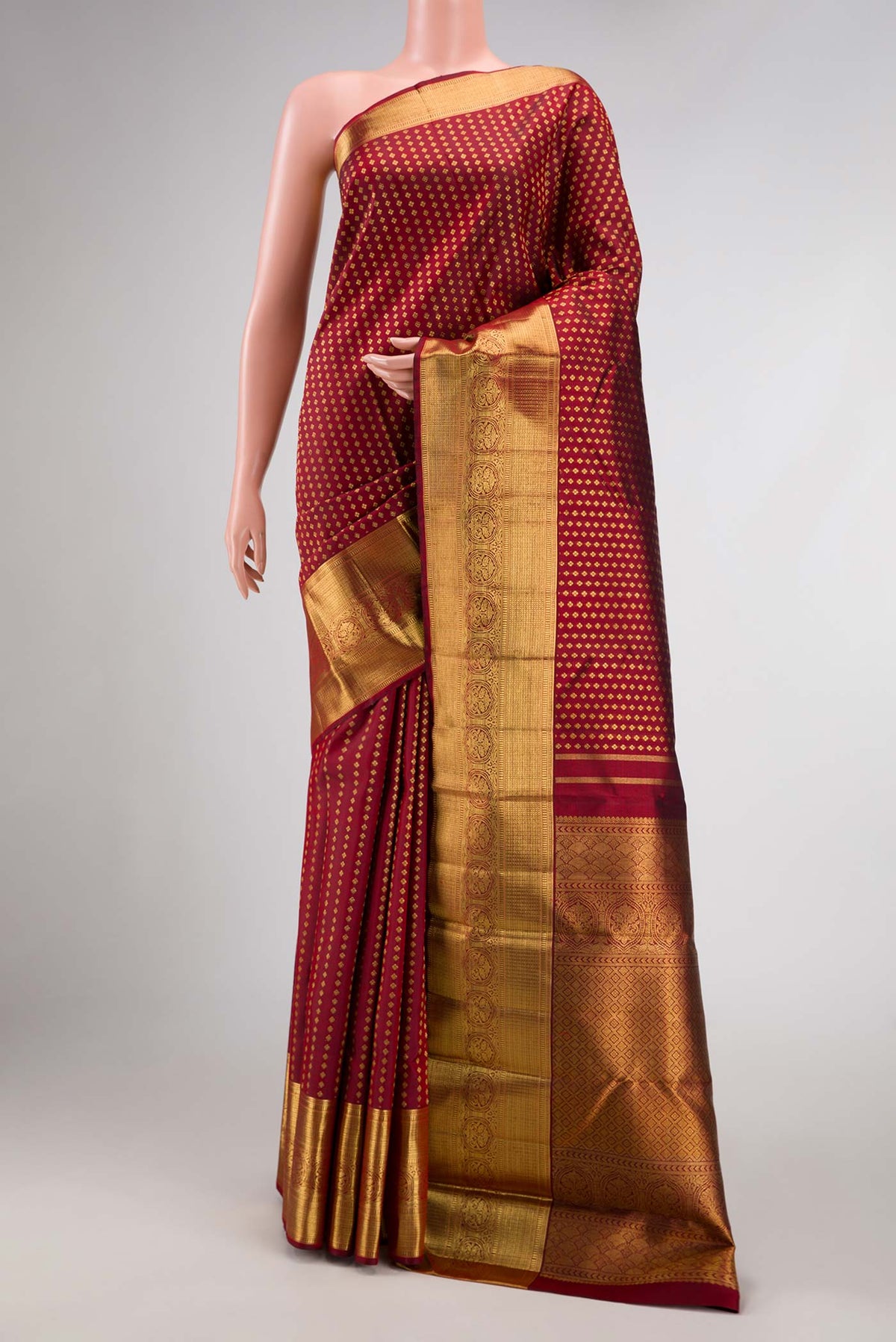 Pure Silk Pure Zari Maroon Dual Tone Kanchipuram Saree with Zari Brocade on the body and Zari Border displayed on a mannequin