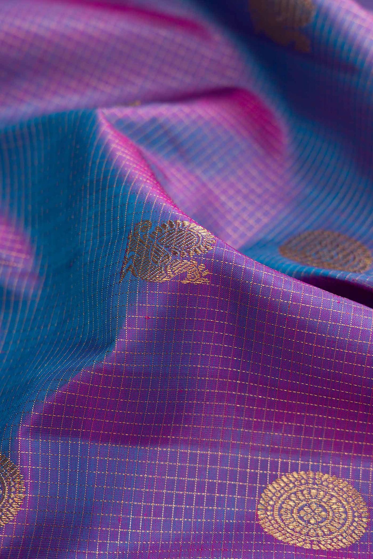 Close up of Pure Silk Pure Zari Lavender Dual Tone Kanjivaram Saree with Zari Butta on the body and Zari Border.  displaying folds