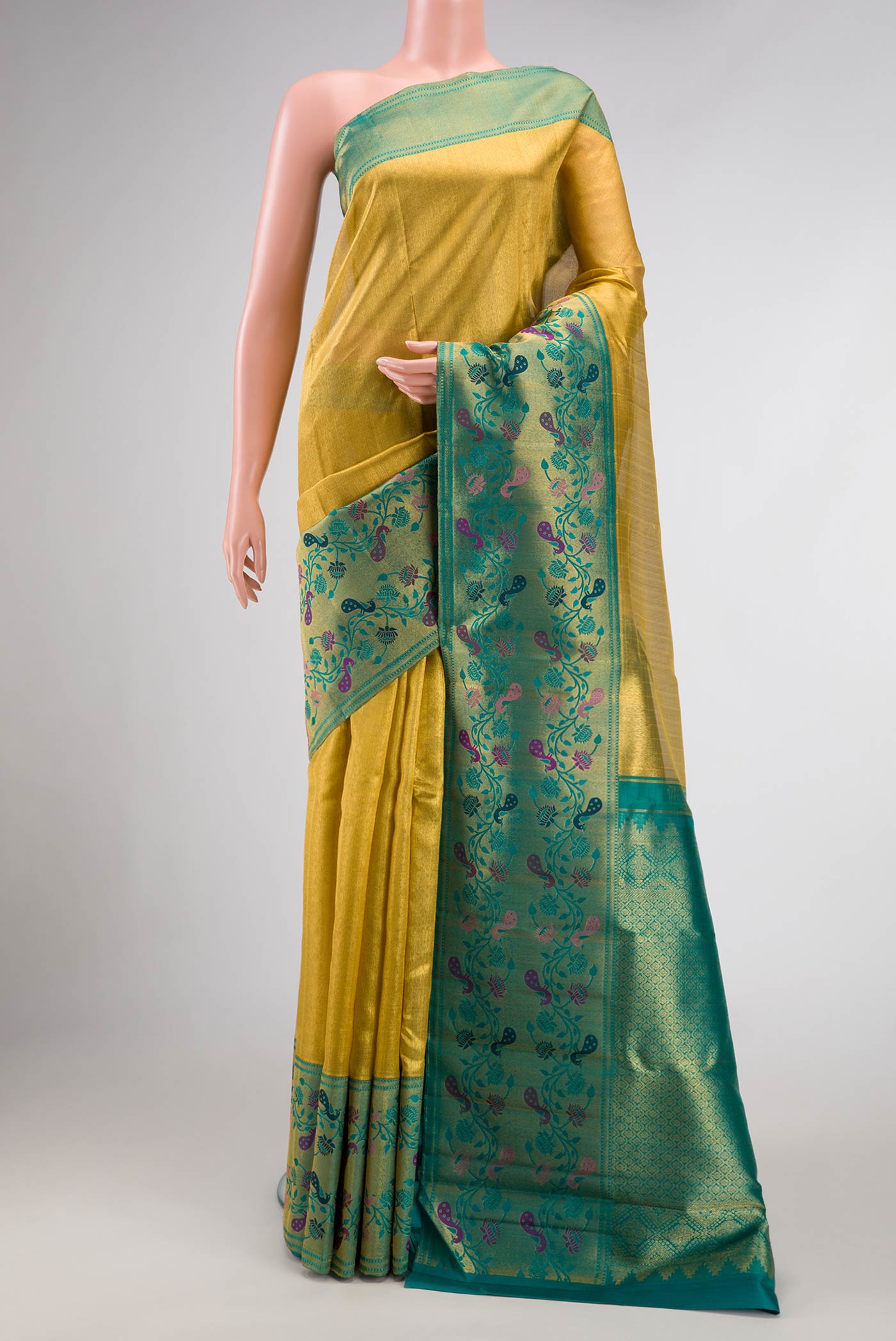 Gold Dual Tone Kanjivaram Tissue Silk Saree with Zari Brocade on the body and Zari And Thread Border.  displayed on a mannequin