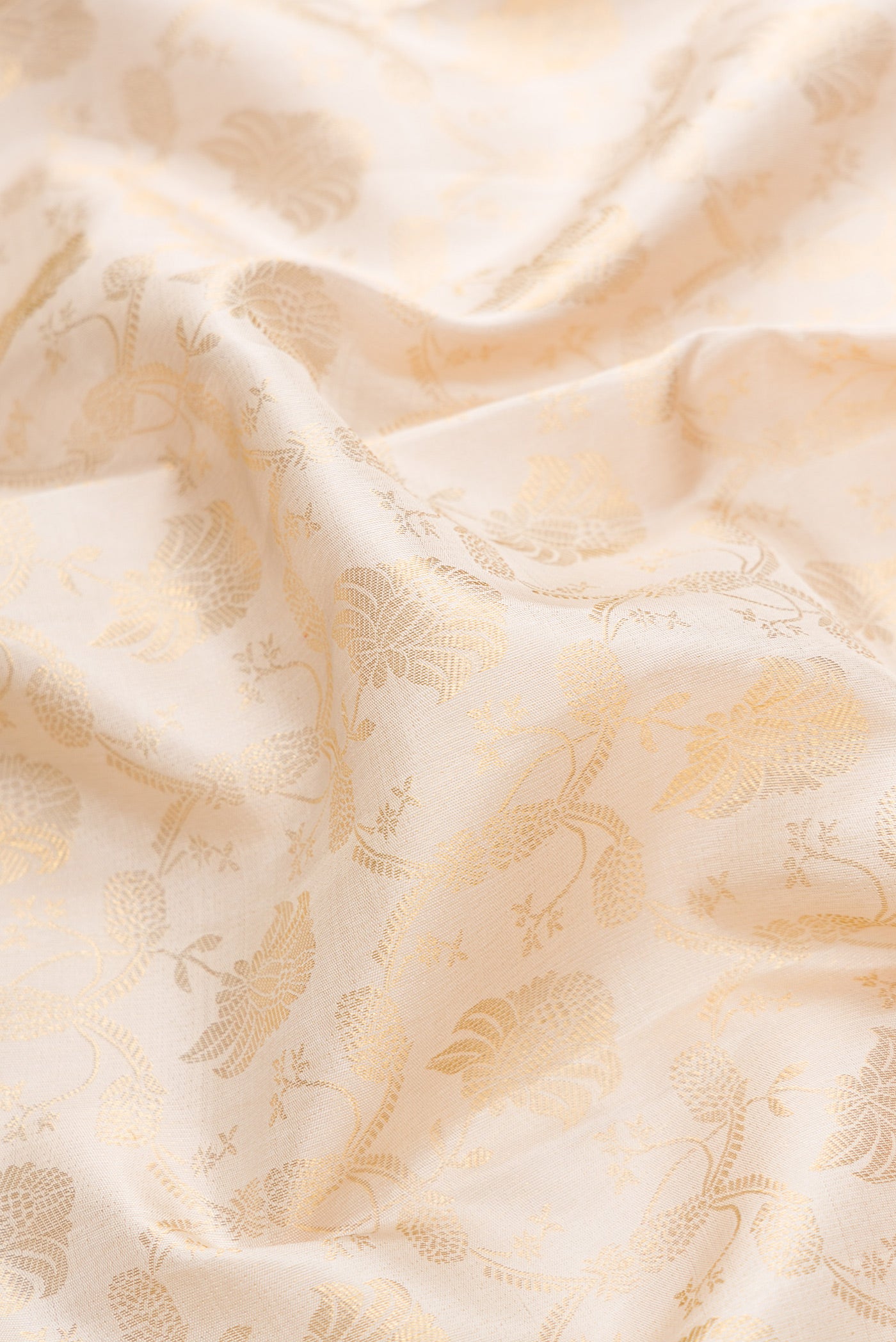 Close up of Off White Dual Tone Kanchipuram Silk Saree with Zari Brocade on the body and Zari Border.  displaying folds