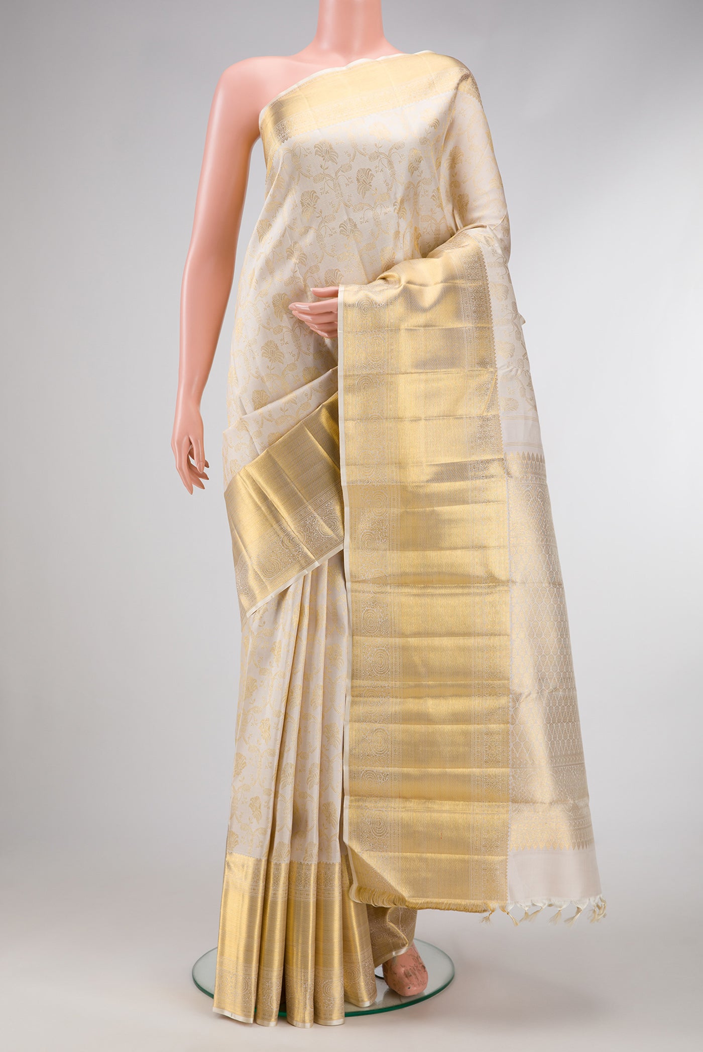 Off White Dual Tone Kanchipuram Silk Saree with Zari Brocade on the body and Zari Border.  displayed on a mannequin