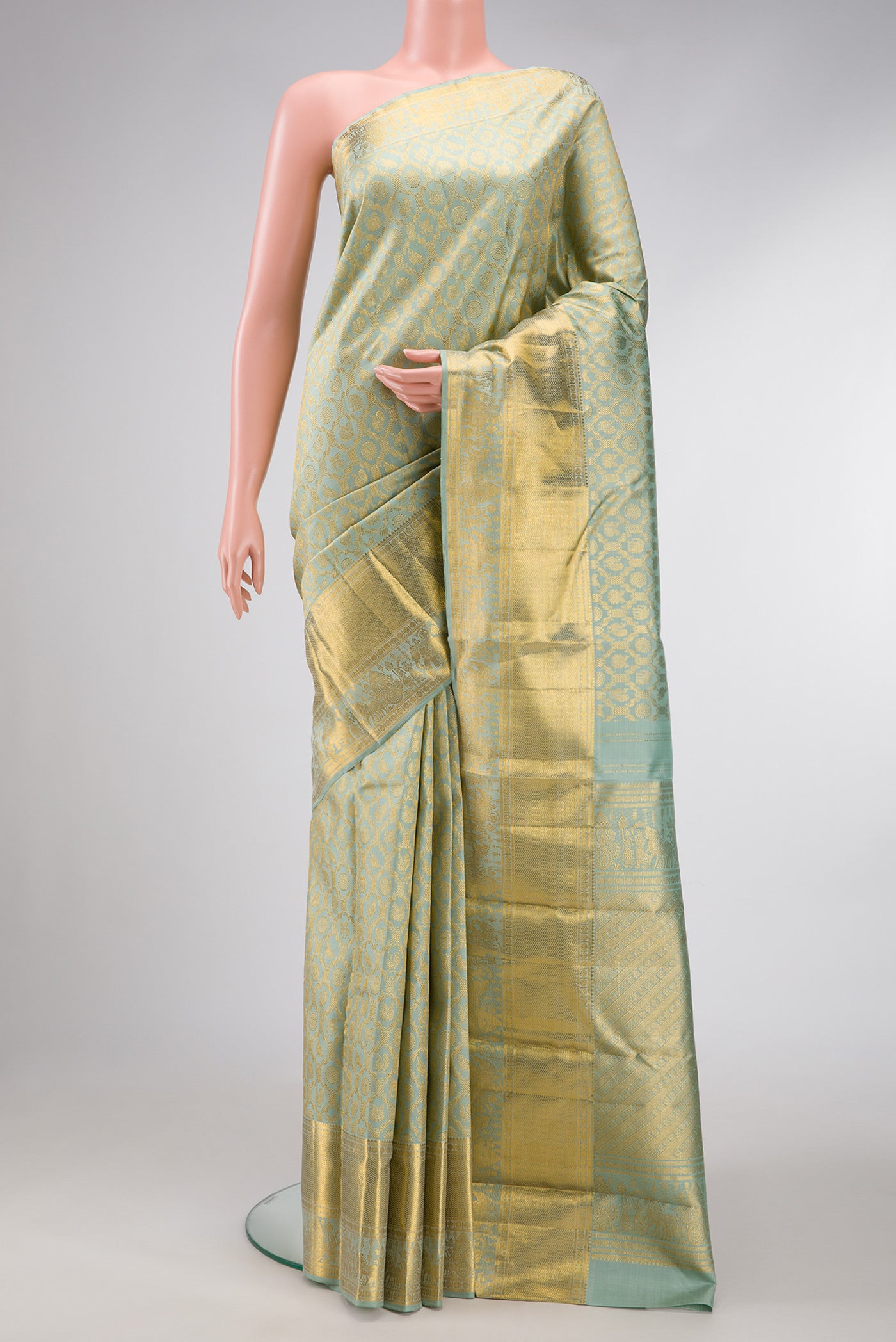 Pista Green Dual Tone Kanchipuram Silk Saree with Zari Brocade on the body and Zari Border.  displayed on a mannequin