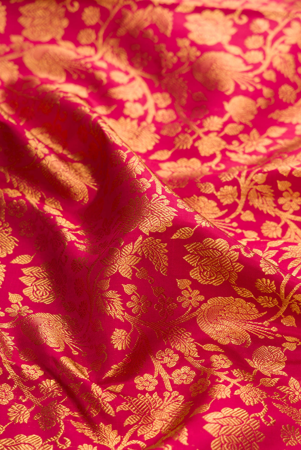 Close up of Maroon Dual Tone Kanchipuram Silk Saree with Zari Brocade on the body and Zari Border.  displaying folds