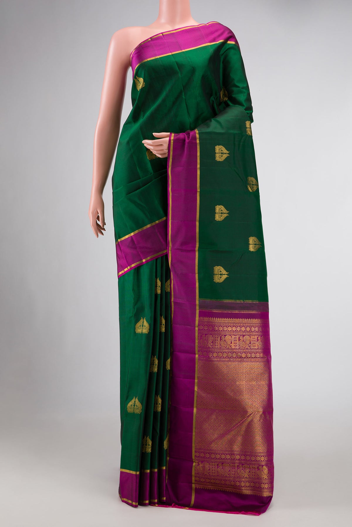 Green Dual Tone Kanchipuram Silk Saree with Zari Butta on the body and Zari Border displayed on a mannequin