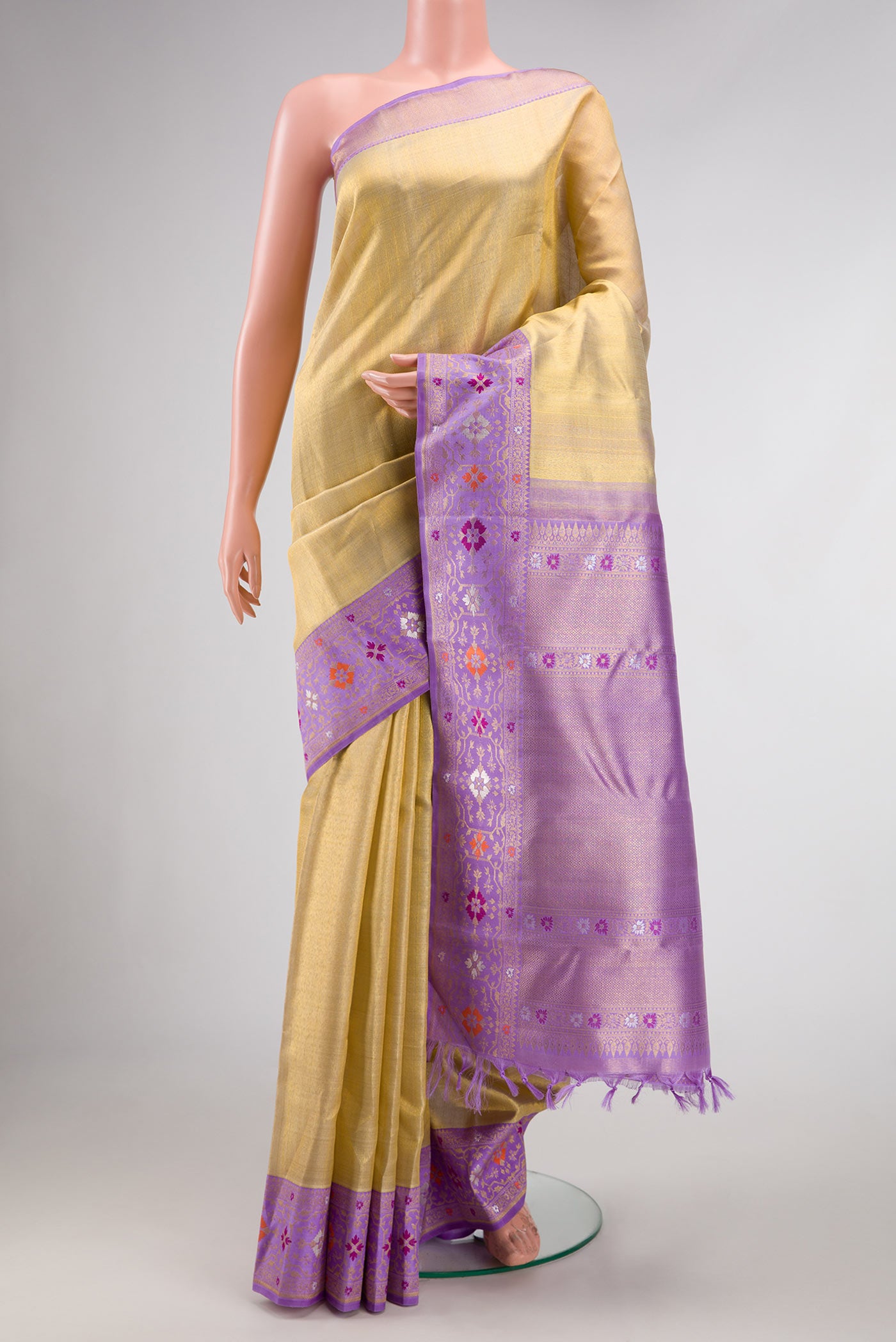 Gold Dual Tone Kanjivaram Tissue Silk Saree with Zari Brocade on the body and Zari And Thread Border.  displayed on a mannequin