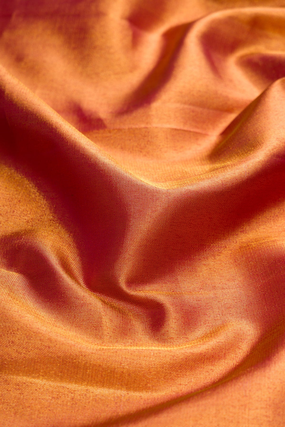 Close up of Maroon Dual Tone Kanjivaram Silk Saree with Zari Brocade on the body and Zari Border.  displaying folds