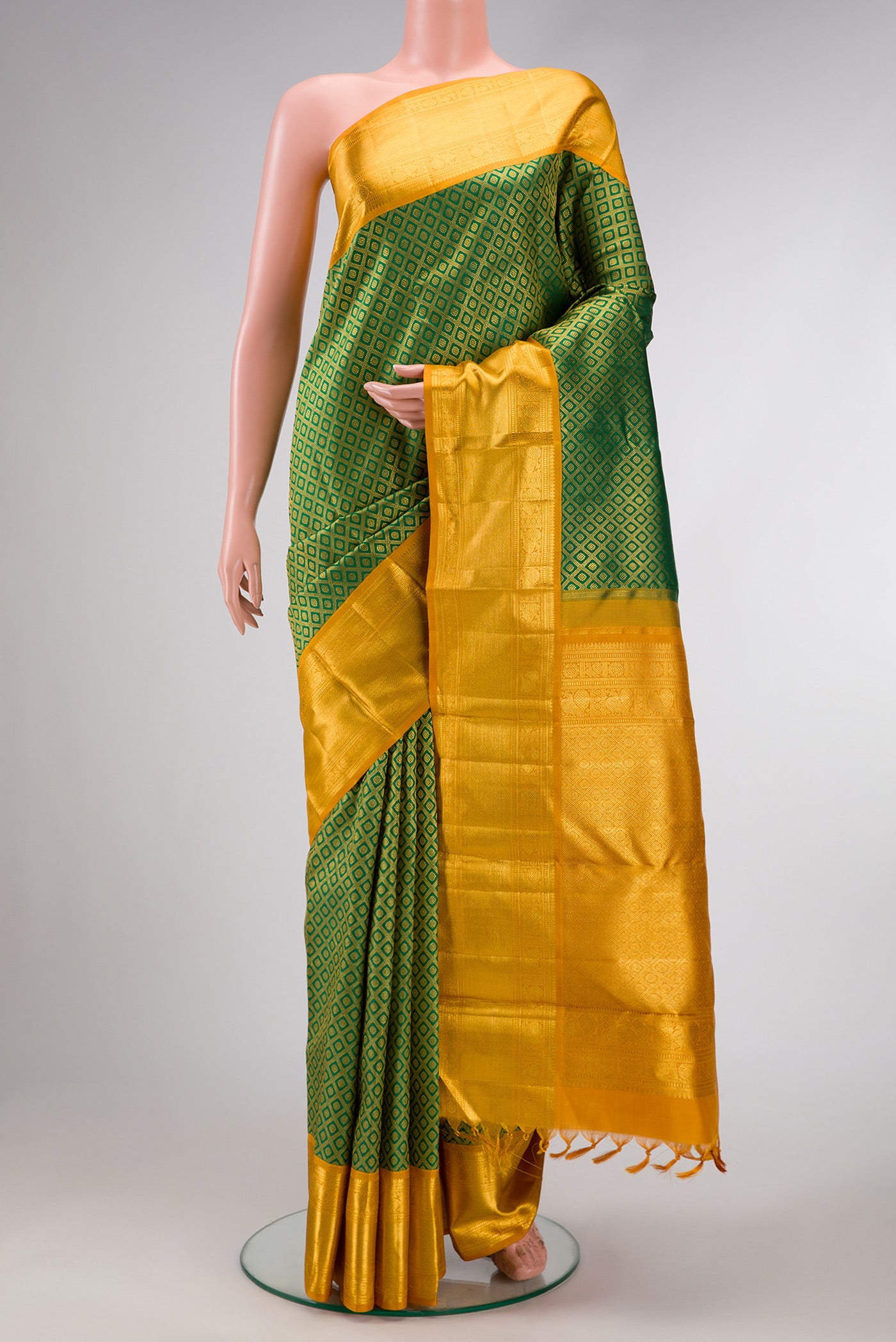 Green Dual Tone Kanchipuram Silk Saree with Zari Brocade on the body and Zari Border.  displayed on a mannequin