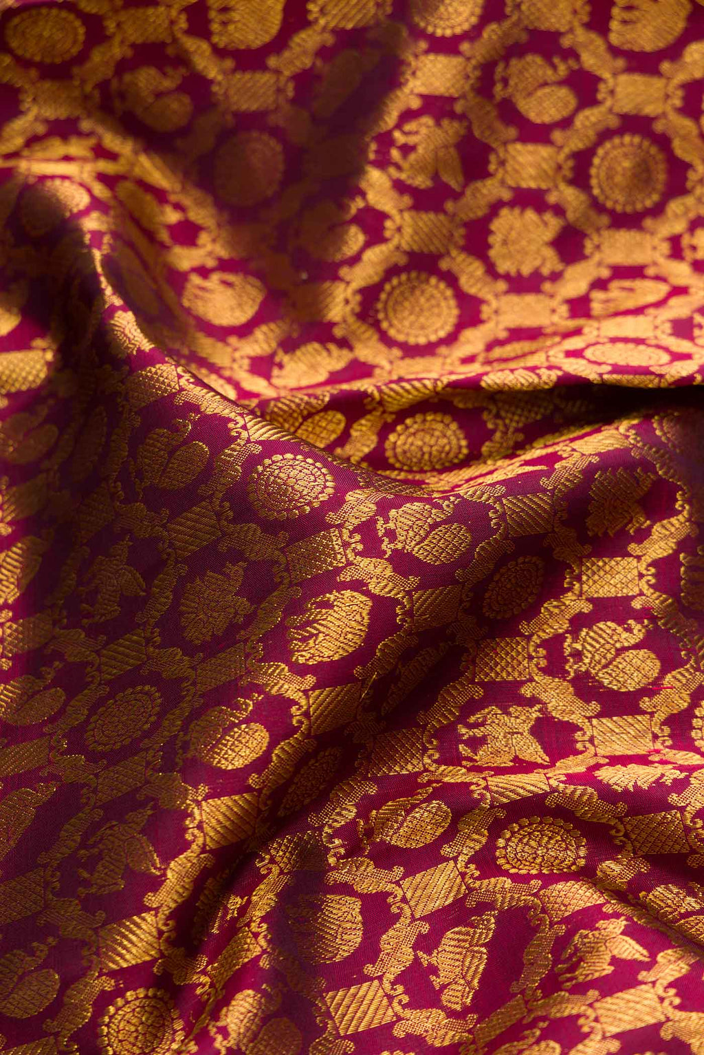 Close up of Maroon Dual Tone Kanchipuram Silk Saree with Zari Brocade on the body and Zari Border.  displaying folds