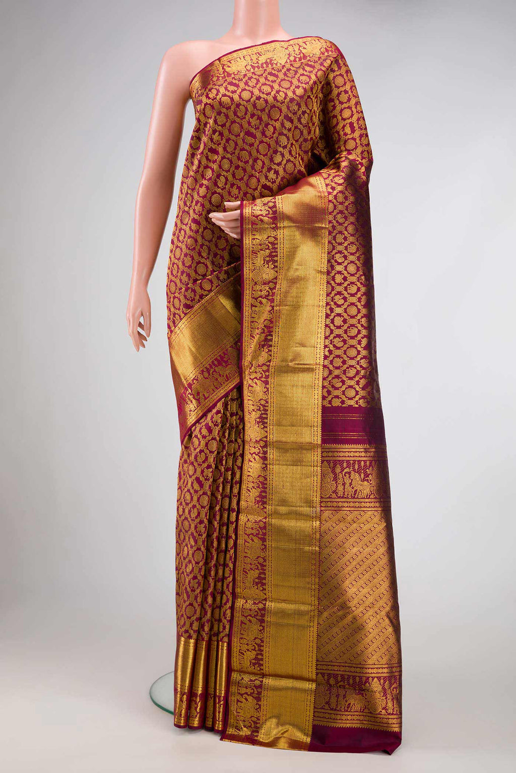 Maroon Dual Tone Kanchipuram Silk Saree with Zari Brocade on the body and Zari Border.  displayed on a mannequin
