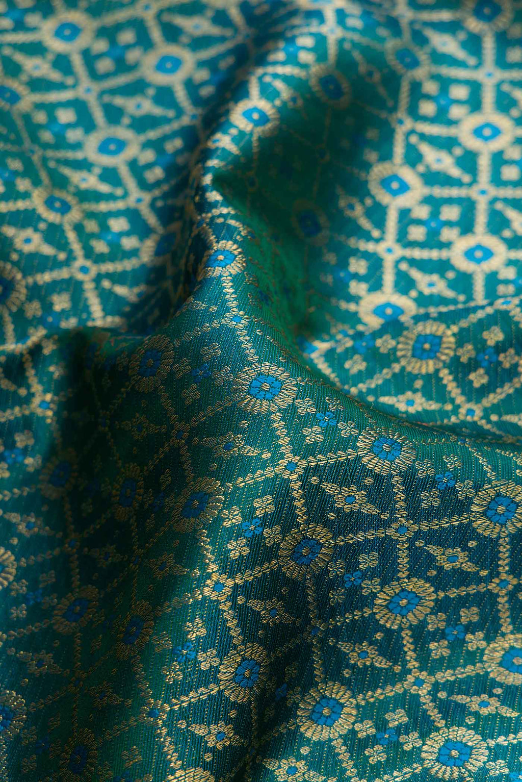 Close up of Peacock Blue Dual Tone Kanchipuram Silk Saree with Zari Brocade on the body and Zari Border.  displaying folds