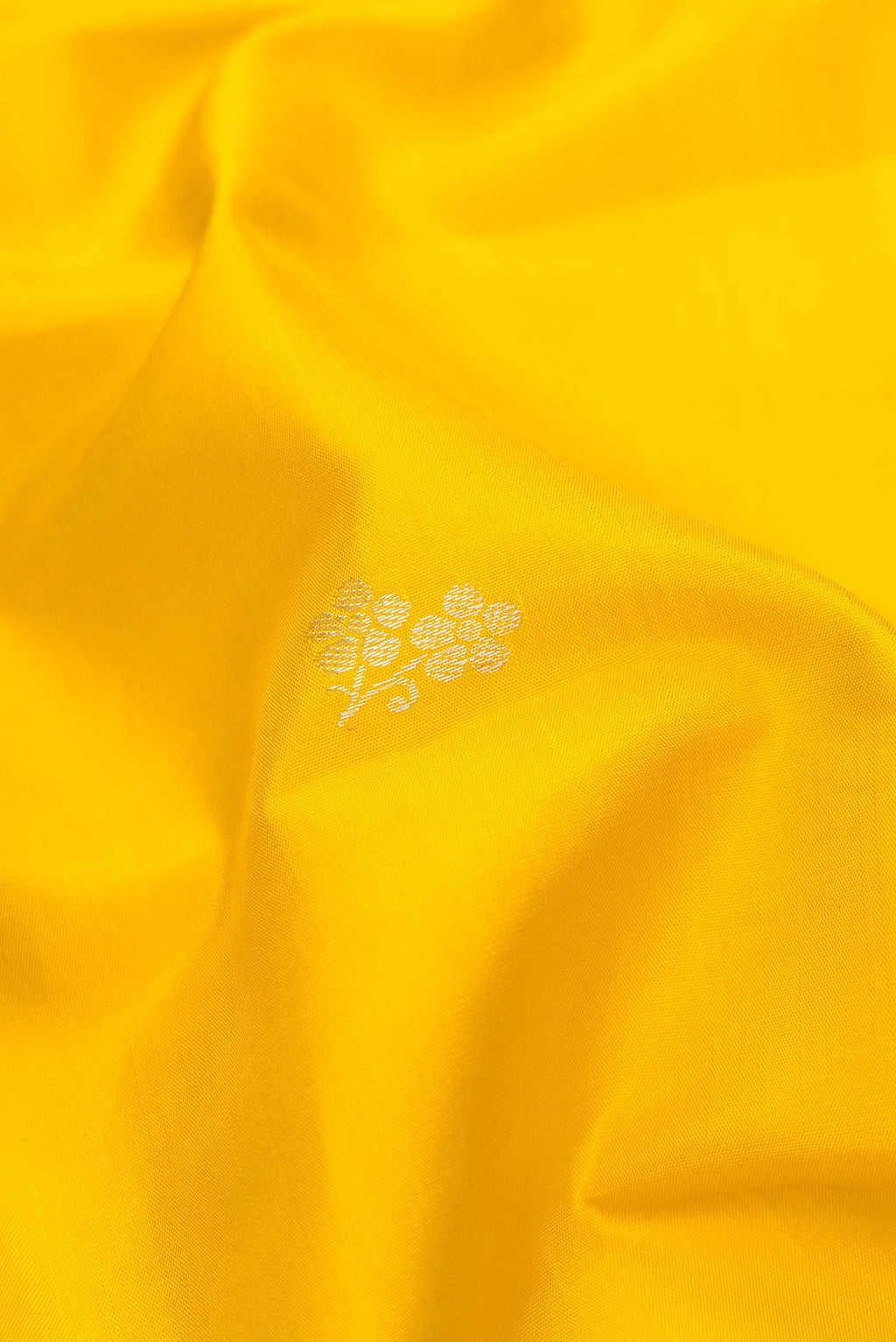Close up of Pure Silk Pure Zari Yellow Dual Tone Kanchipuram Saree with Zari Butta on the body and Fancy Border.  displaying folds