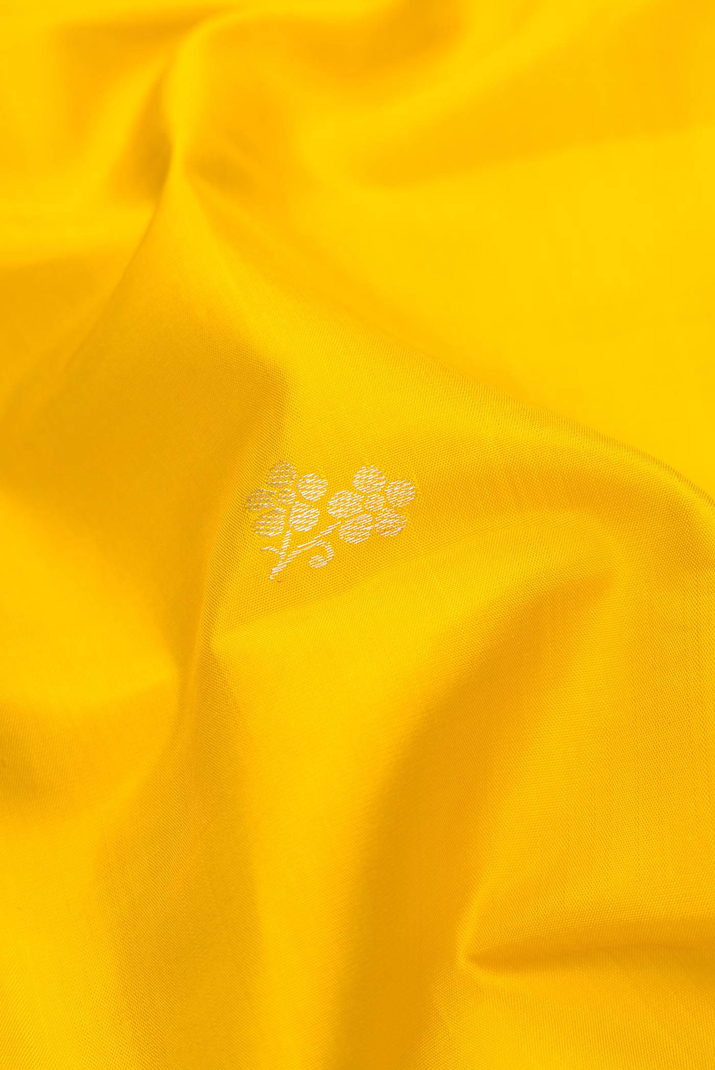 Close up of Pure Silk Pure Zari Yellow Dual Tone Kanchipuram Saree with Zari Butta on the body and Fancy Border.  displaying folds