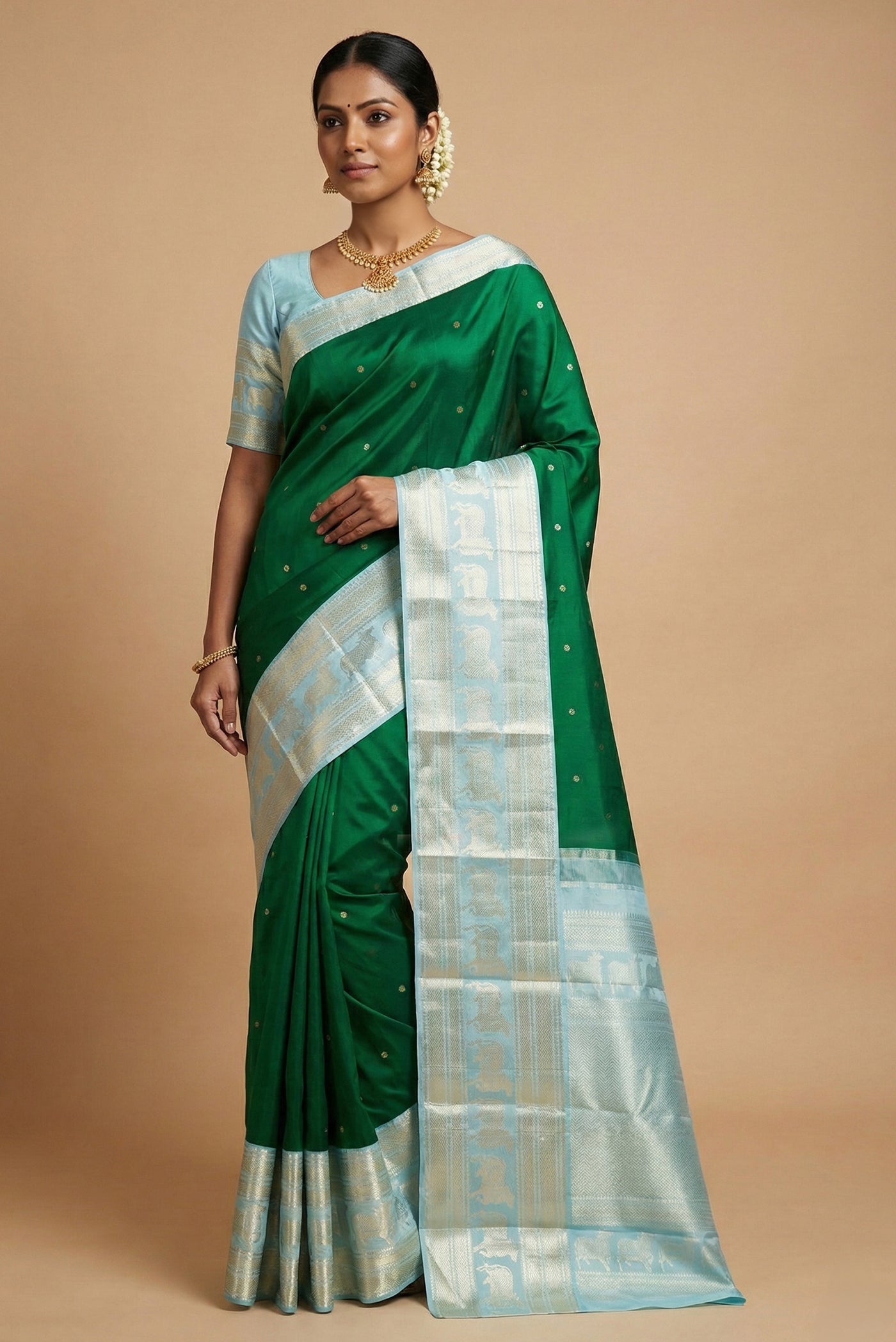 Model wearing a Green Dual Tone Kanchipuram Silk Saree with Zari Butta on the body and Zari Border.