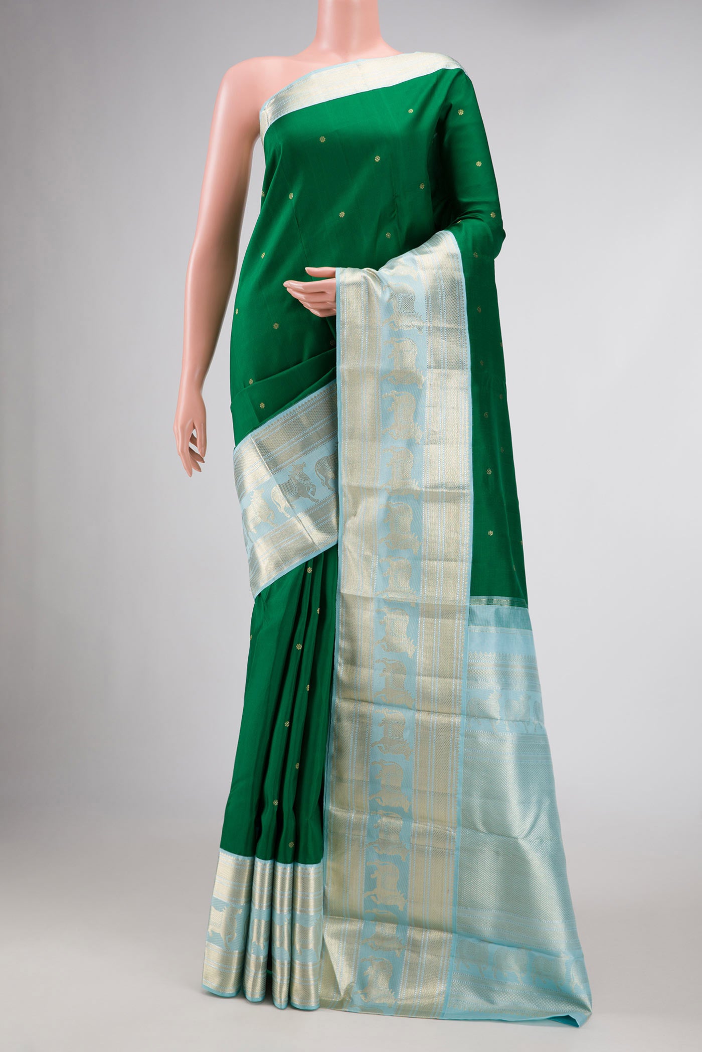 Green Dual Tone Kanchipuram Silk Saree with Zari Butta on the body and Zari Border.  displayed on a mannequin