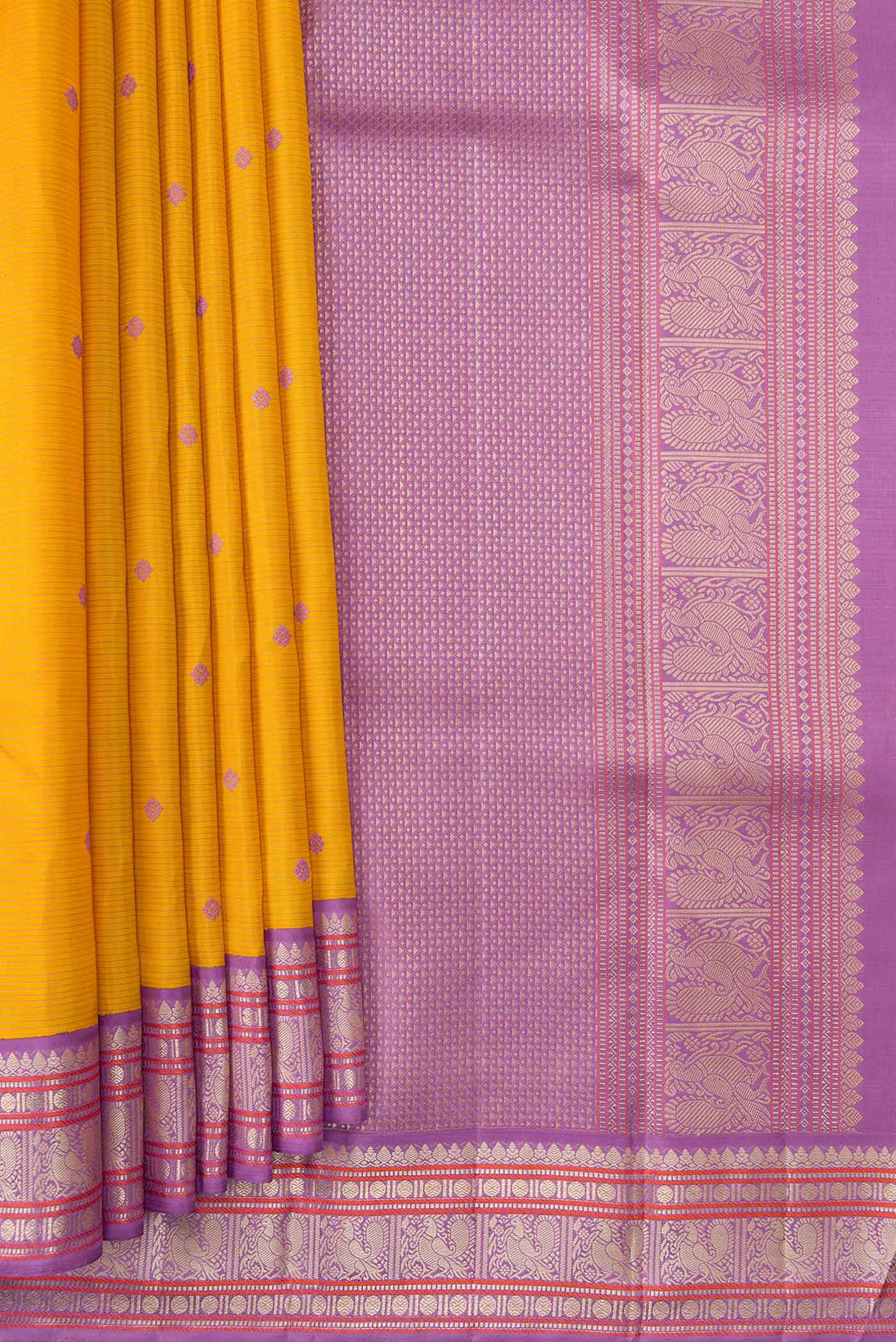 Pleats and pallu of Pure Silk Pure Zari Mustard Dual Tone Kanchipuram Saree with Thread Butta on the body and Zari Border. 