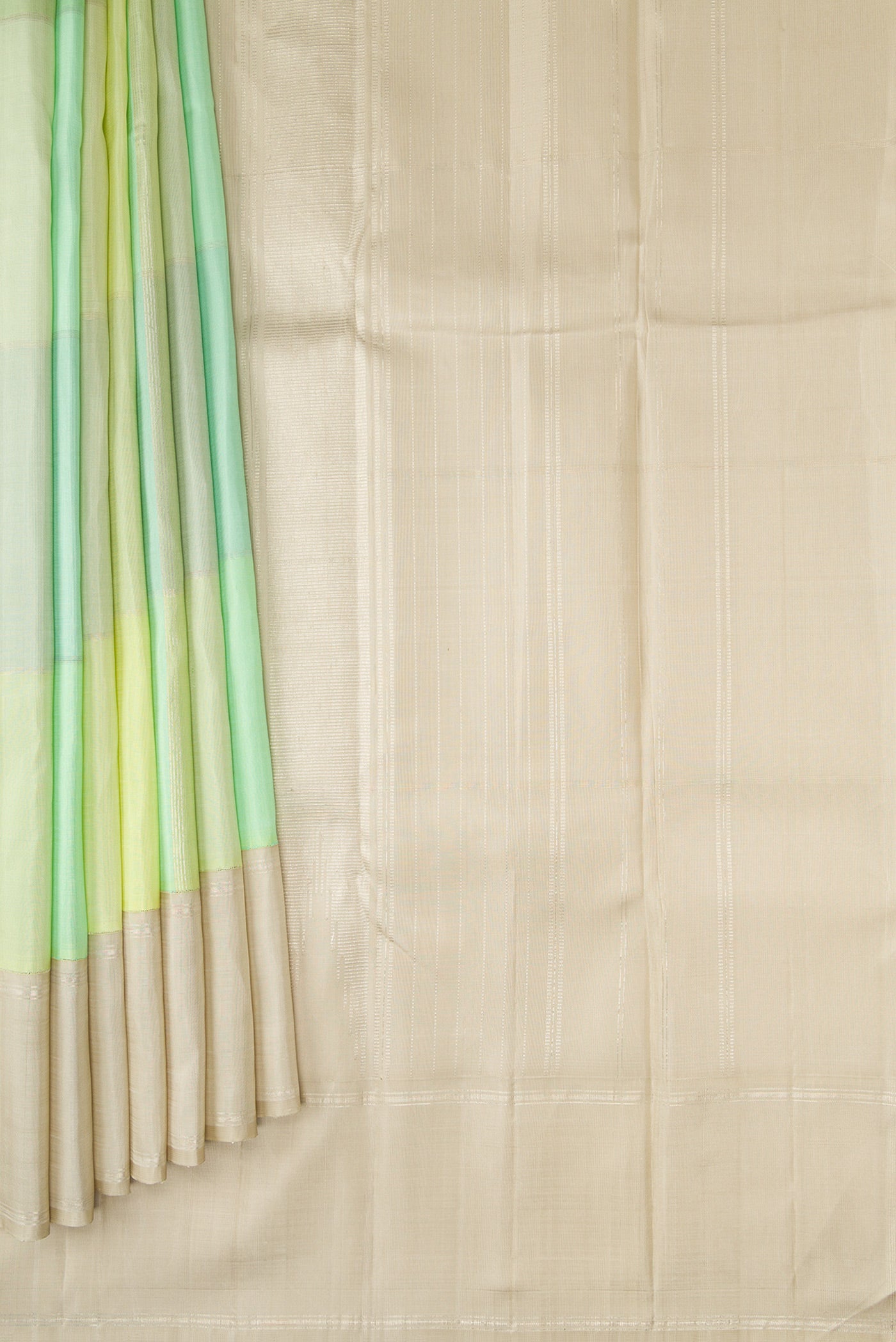 Pleats and pallu of Light Green and Sea Green Color Kanchipuram Silk Saree with Checked design on the body and Zari Border. 