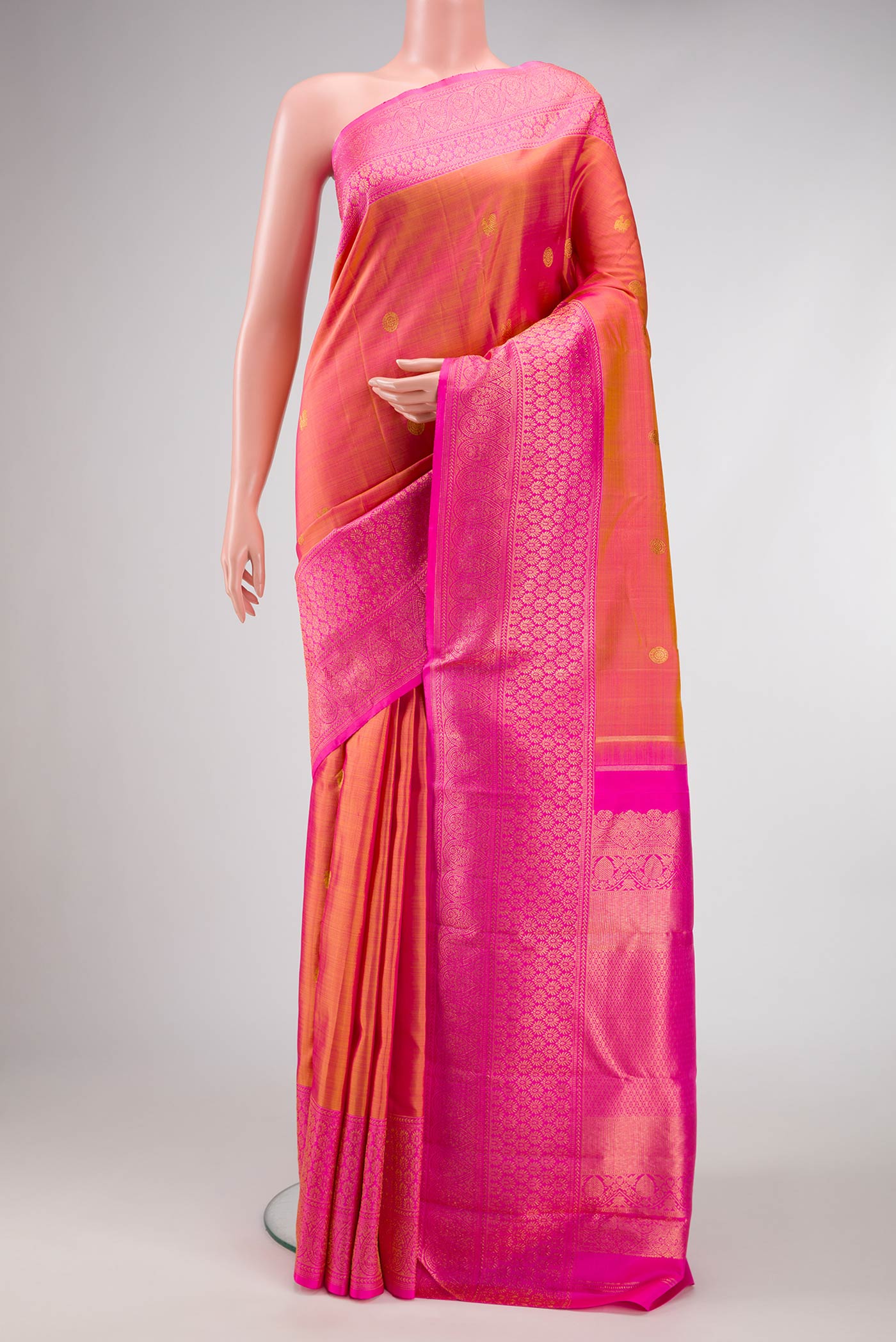 Mustard Dual Tone Kanjivaram Silk Saree with Zari Butta on the body and Zari Border.  displayed on a mannequin