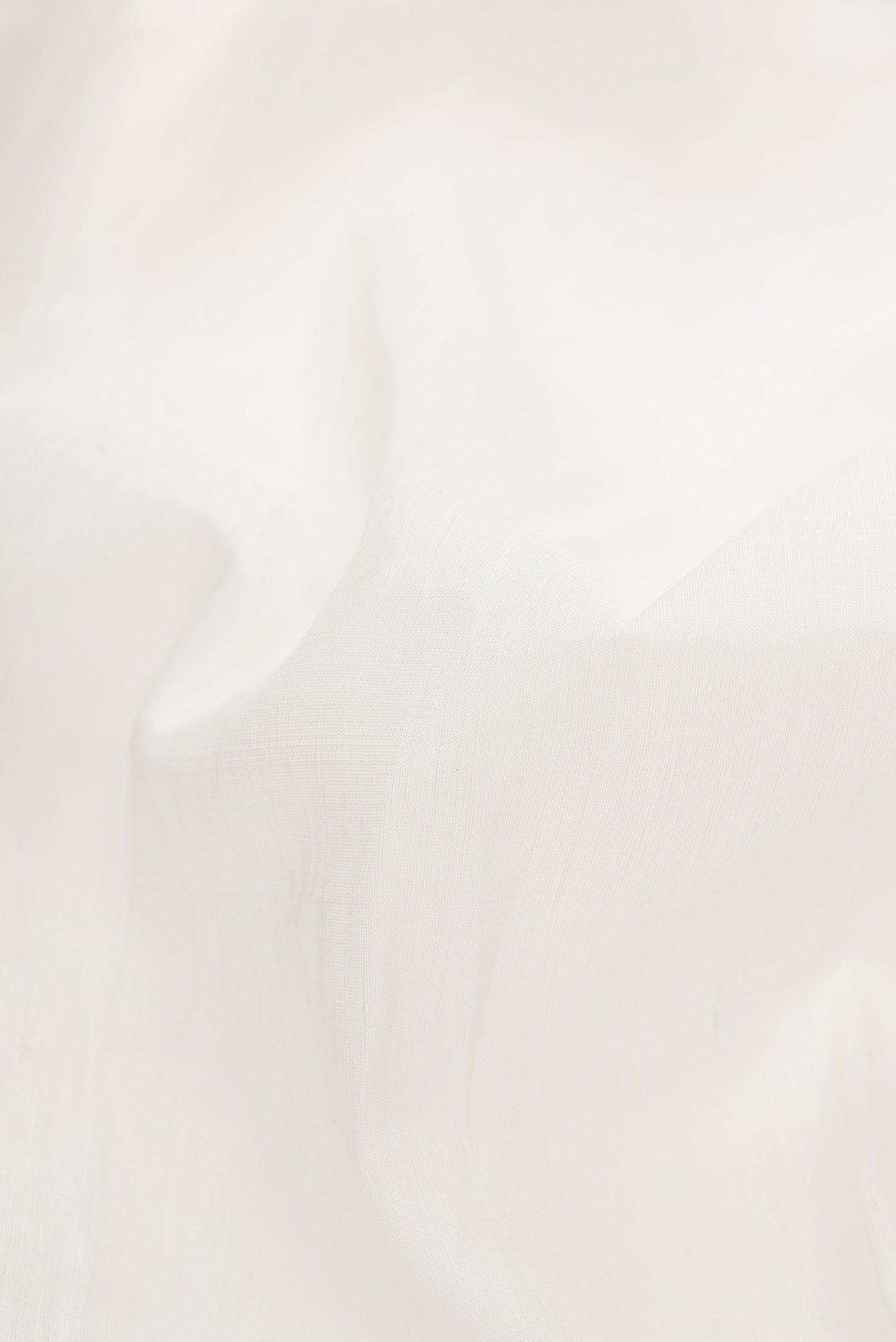 Close up of Off White Dual Tone Linen Saree with Plain Body and Checks Border.  displaying folds