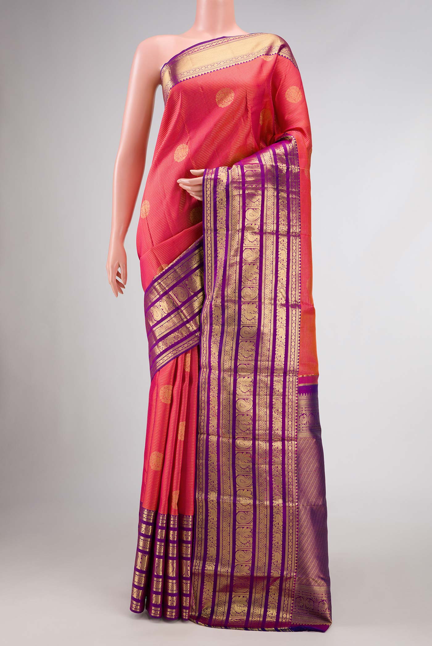 Coral Dual Tone Kanjivaram Silk Saree with Zari Butta on the body and Zari Border.  displayed on a mannequin
