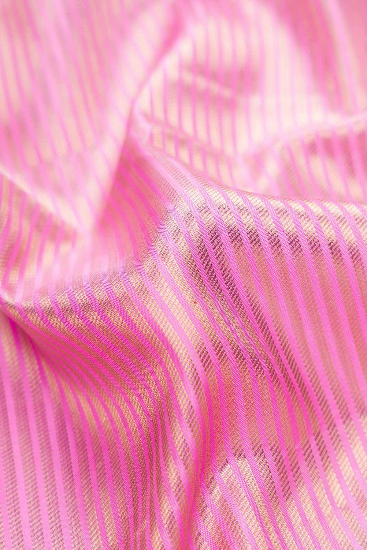 Close up of Pure Silk Pure Zari Pink Dual Tone Kanchipuram Saree with Zari Brocade on the body and Zari Border displaying folds