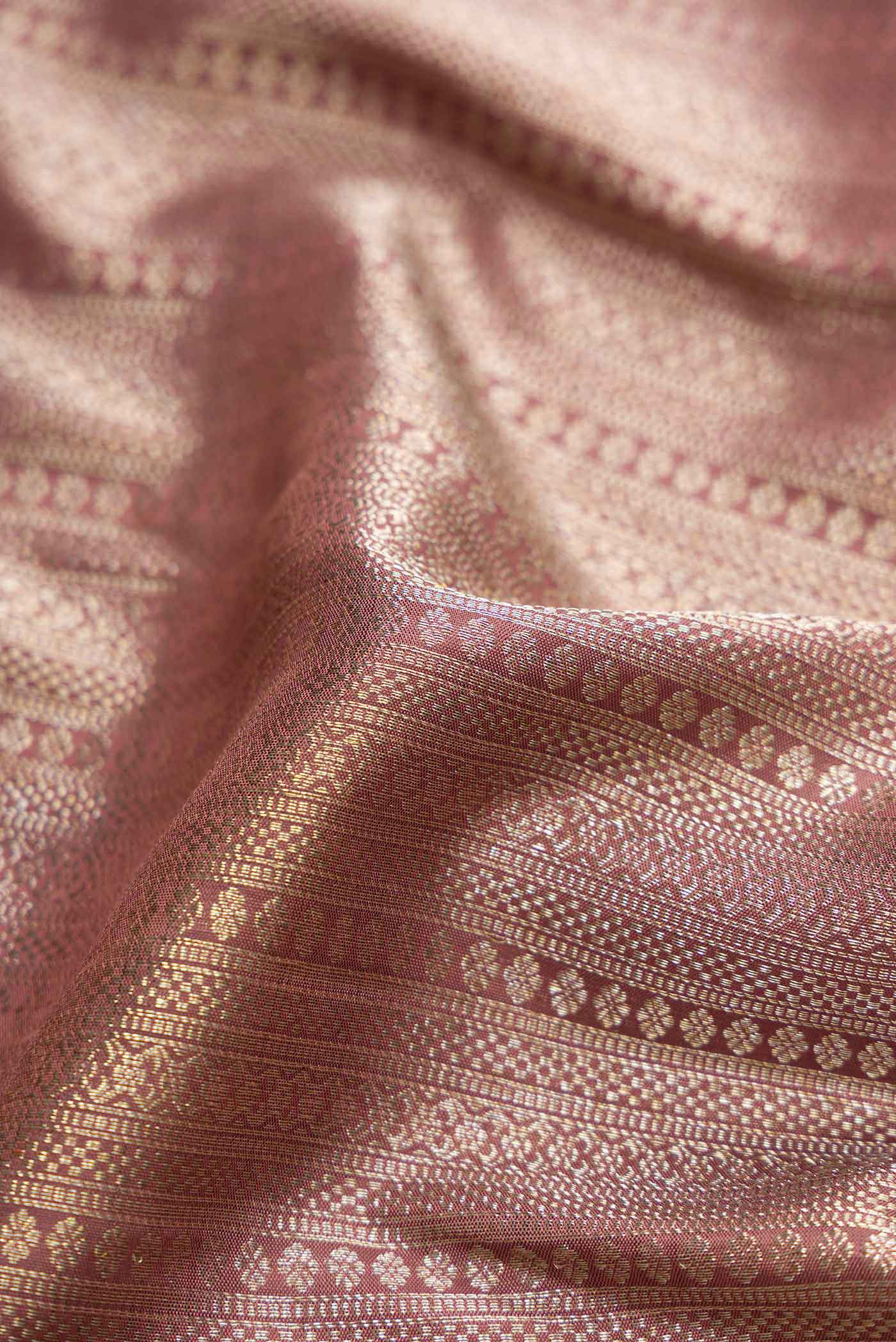 Close up of Pure Silk Pure Zari Brown Dual Tone Kanchipuram Saree with Zari Brocade on the body and Fancy Border displaying folds