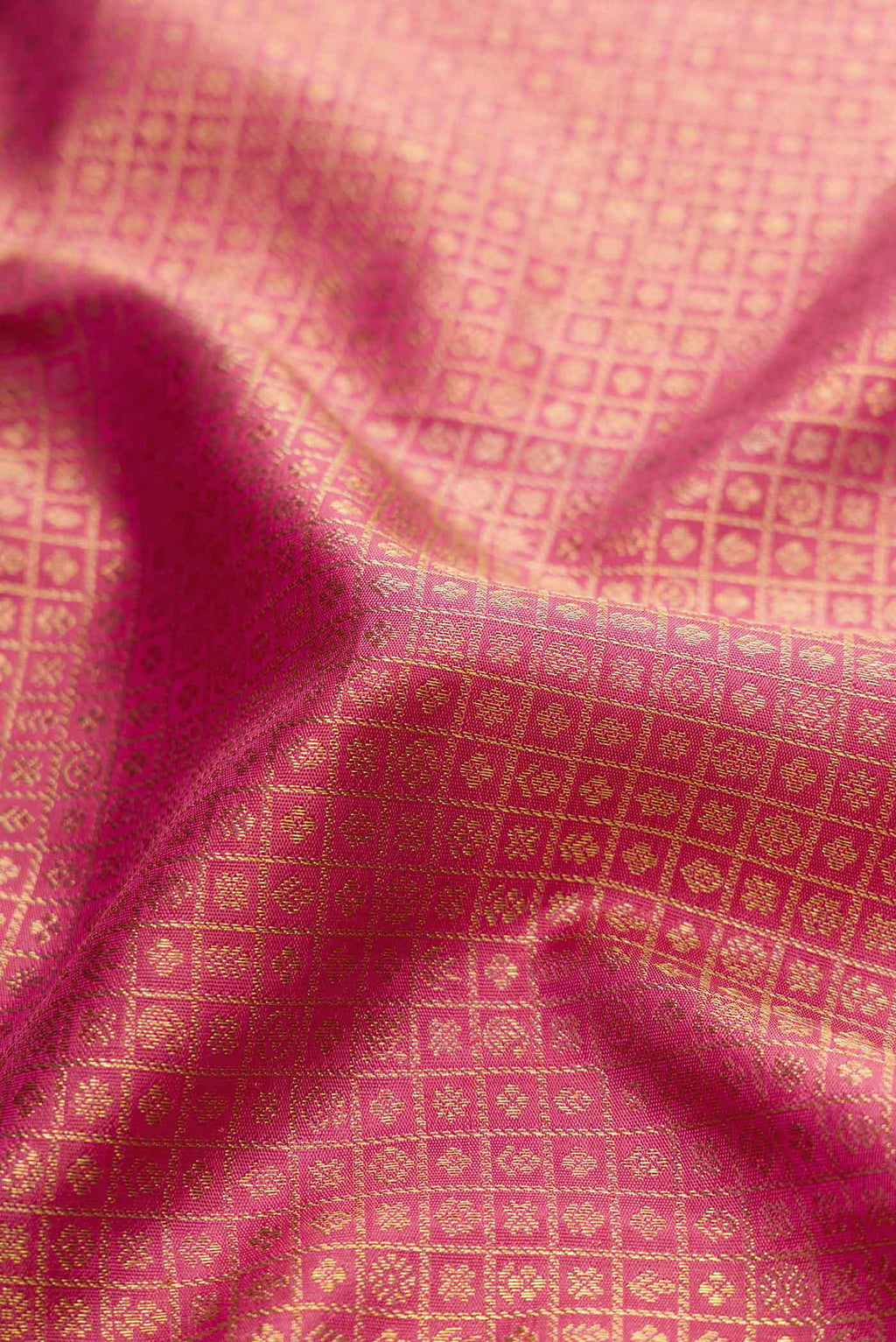 Close up of Pure Silk Pure Zari Pink Dual Tone Kanchipuram Saree with Zari Brocade on the body and Zari Border displaying folds