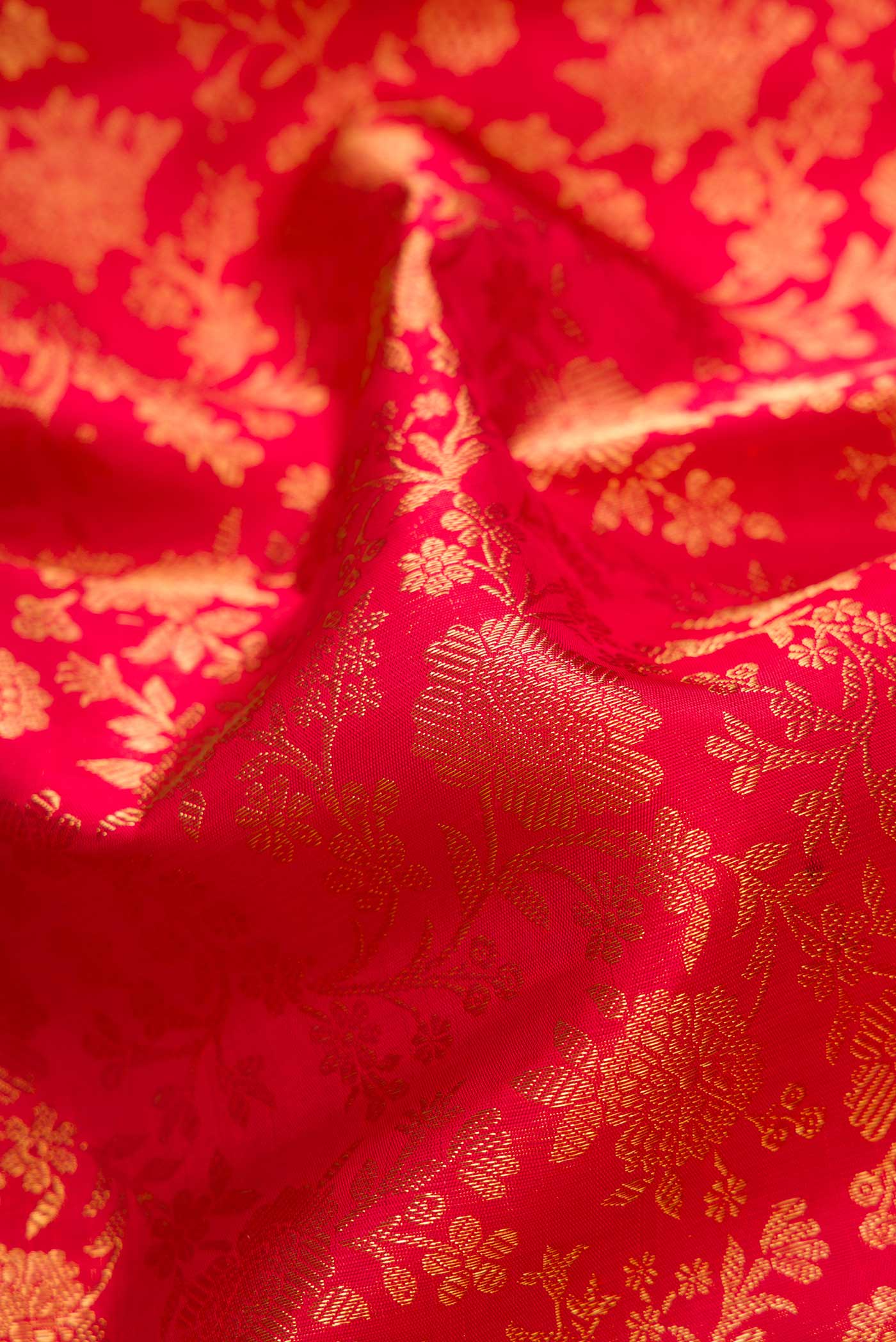 Close up of Pure Silk Pure Zari Maroon Dual Tone Kanjivaram Saree with Zari Brocade on the body and Zari Border.  displaying folds