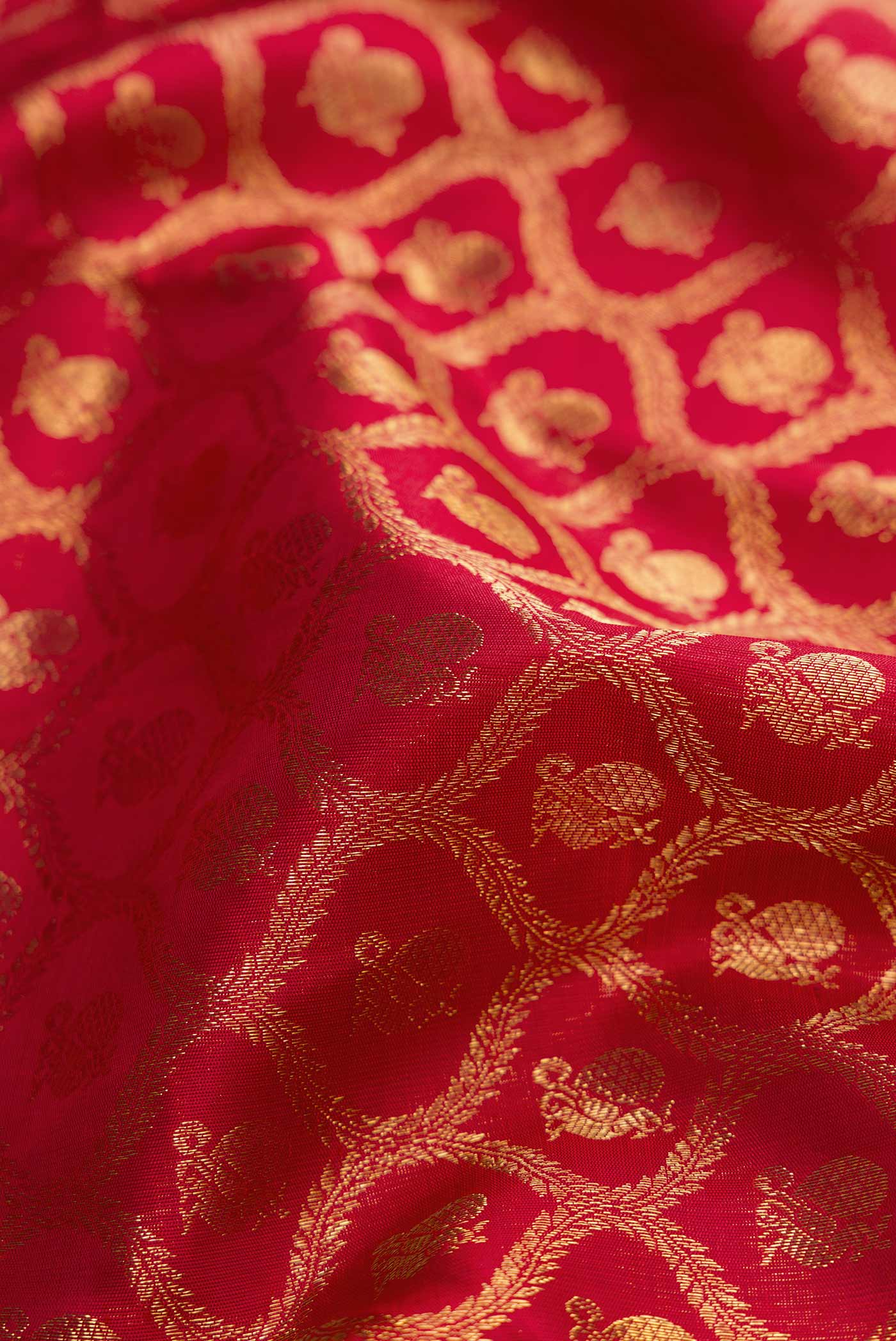 Close up of Pure Silk Pure Zari Red Dual Tone Kanchipuram Saree with Zari Brocade on the body and Zari Border displaying folds
