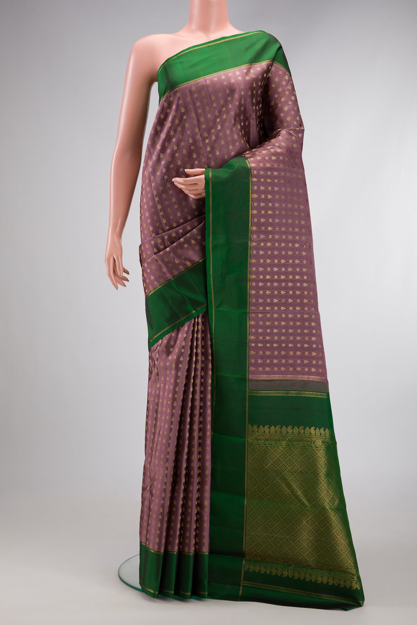 Pure Silk Pure Zari Brown Dual Tone Kanchipuram Saree with Zari And Thread Butta on the body and Zari Border.  displayed on a mannequin