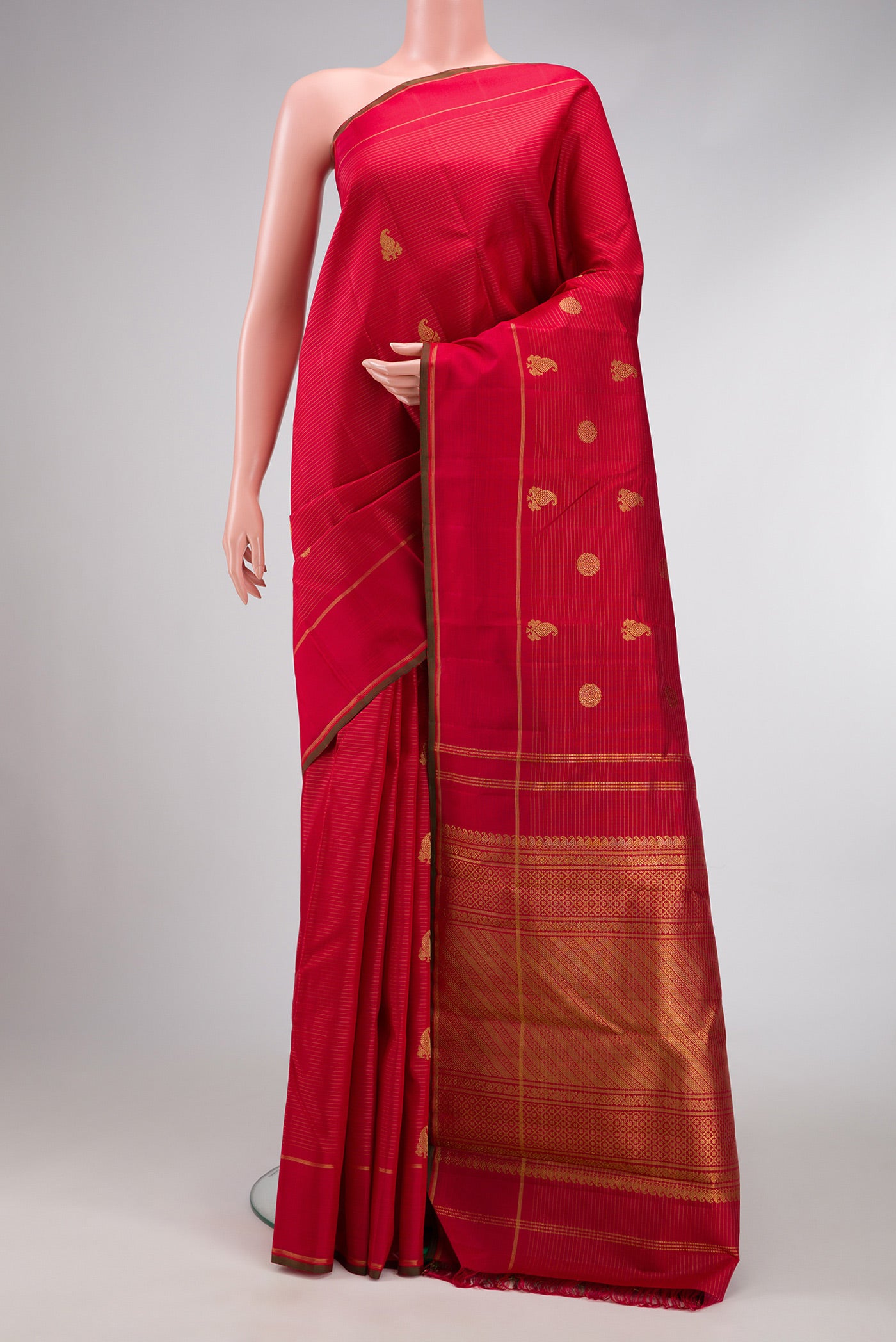 Pure Silk Pure Zari Red Dual Tone Kanchipuram Saree with Zari Butta on the body and Zari Border.  displayed on a mannequin
