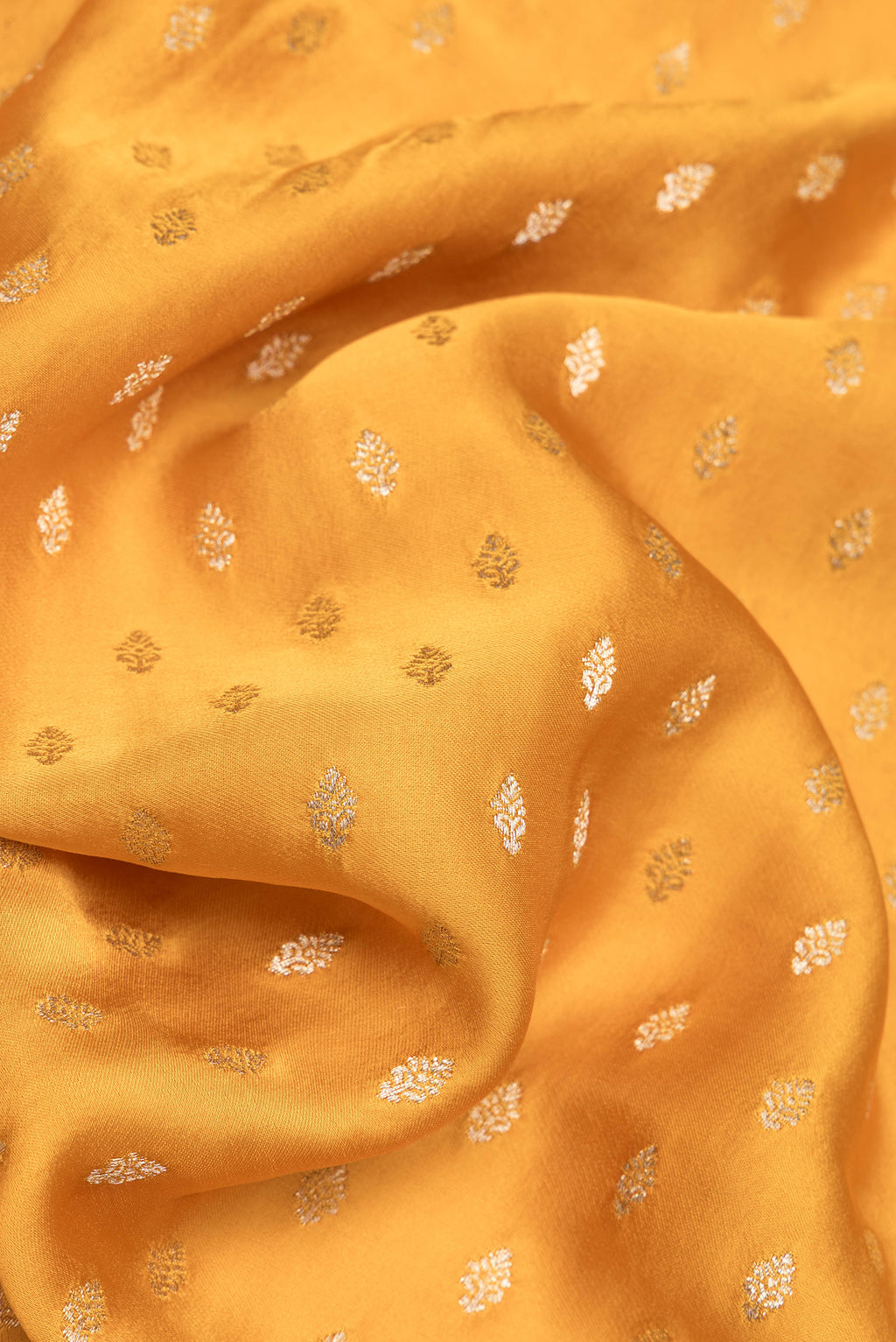 Close up of Mustard Dual Tone Blended Banarasi Silk Saree with Zari Butta on the body and Zari Border.  displaying folds