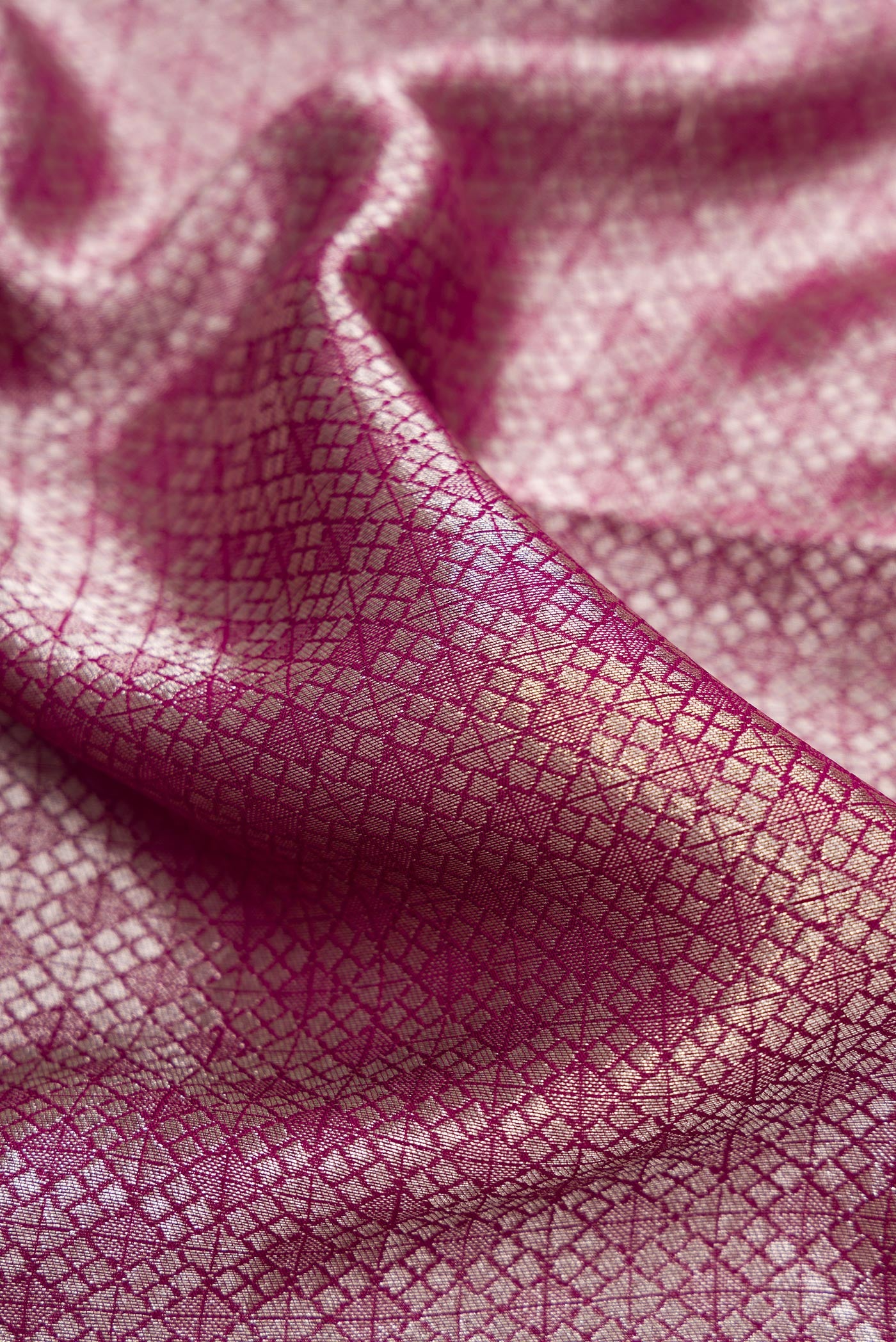 Close up of Magenta Dual Tone Blended Georgette Saree with Zari Brocade on the body and Zari Border.  displaying folds