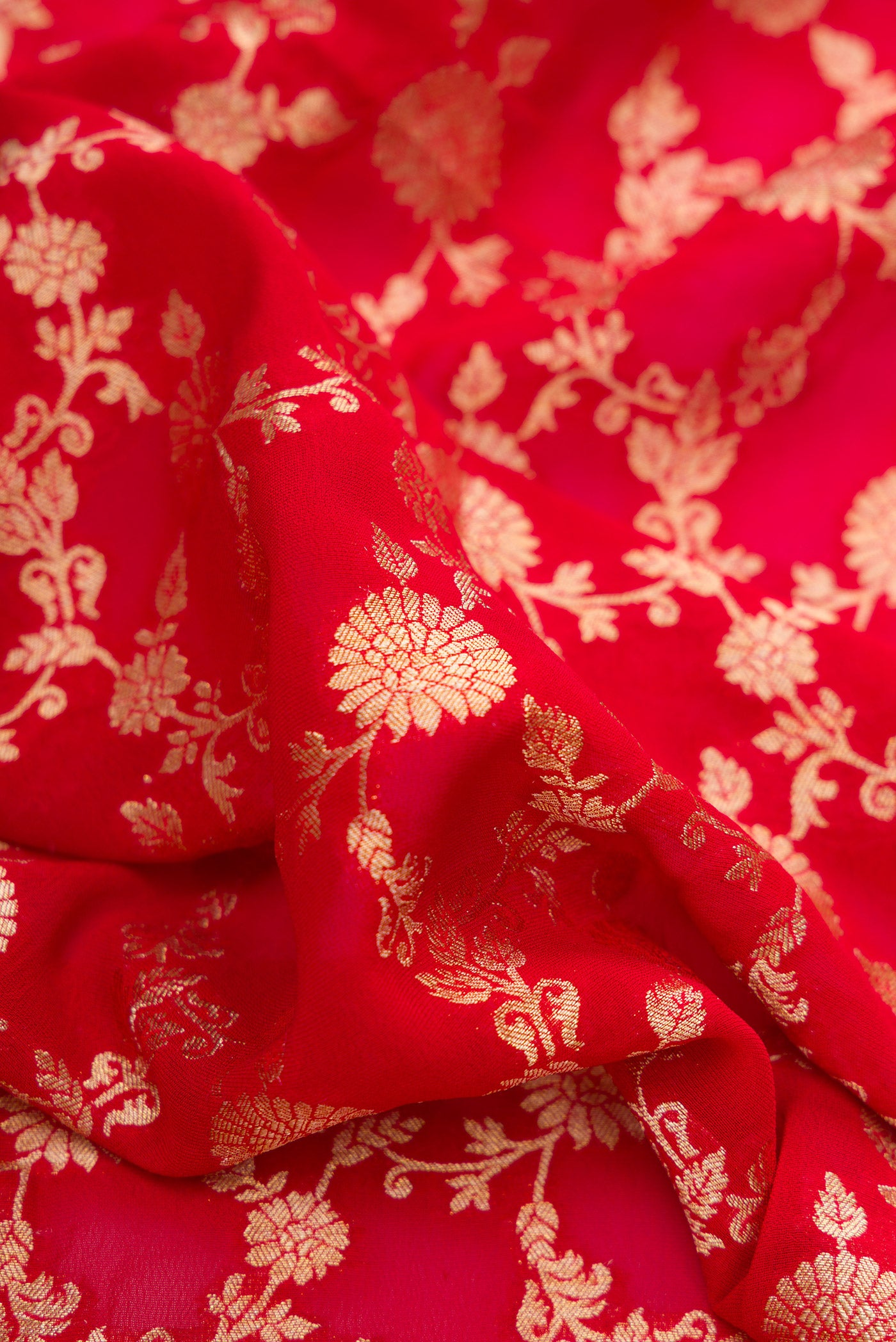 Close up of Red Dual Tone Blended Banarasi Georgette Saree with Zari Brocade on the body and Zari Border.  displaying folds