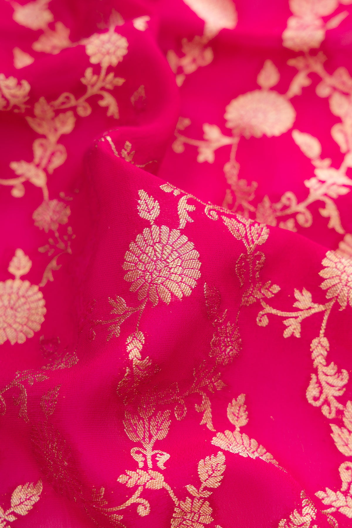 Close up of Pink Blended Banarasi Georgette Saree with Zari Brocade on the body and Zari Border.  displaying folds