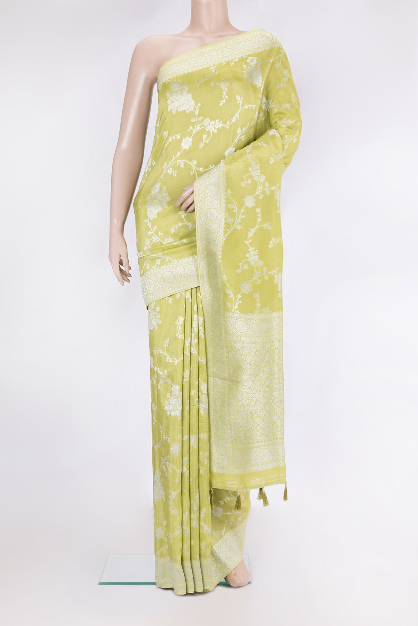 Pista Green Blended Banarasi Silk Saree with Zari Brocade on the body and Fancy Border.  displayed on a mannequin