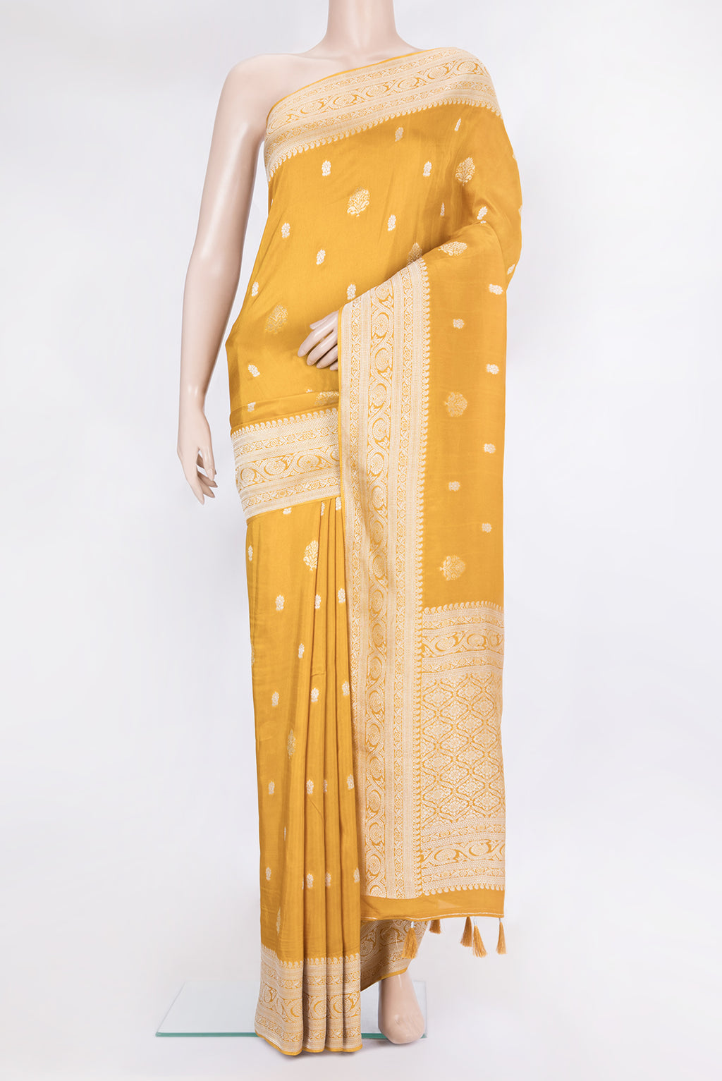 Mustard Blended Banarasi Silk Saree with Zari Butta on the body and Fancy Border.  displayed on a mannequin