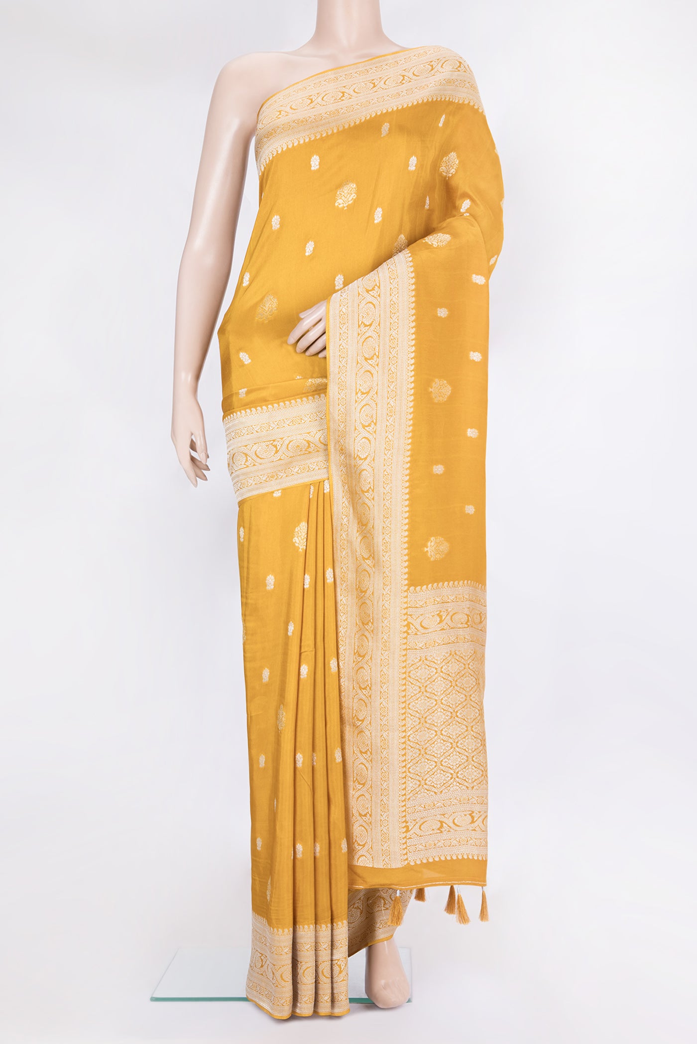 Mustard Blended Banarasi Silk Saree with Zari Butta on the body and Fancy Border.  displayed on a mannequin